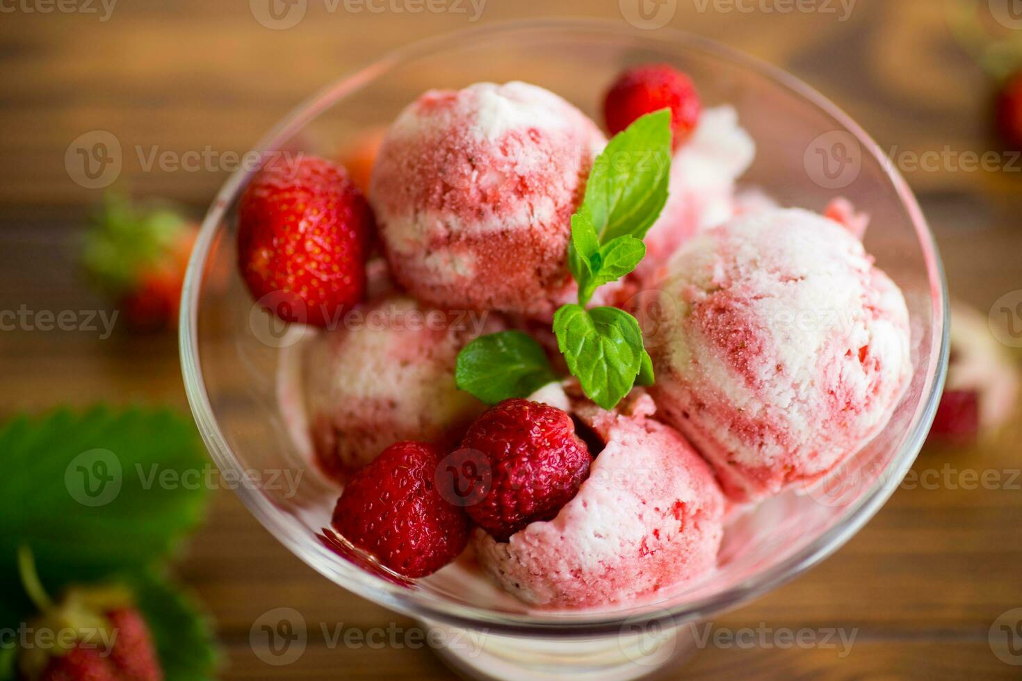 Balls of homemade strawberry ice cream in a bowl photo