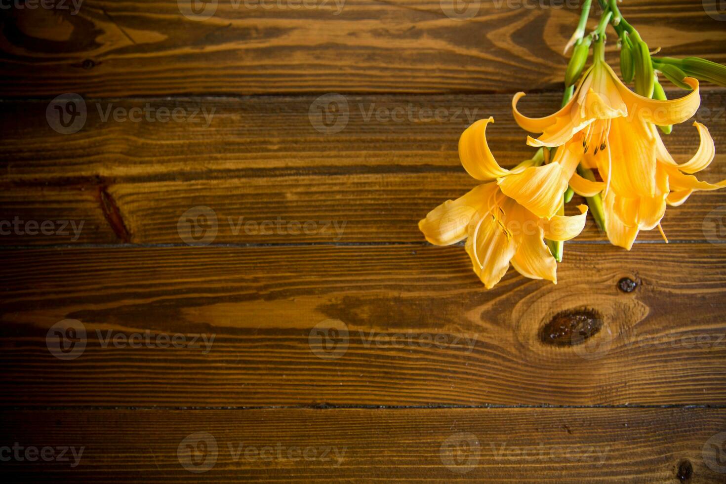 bouquet of beautiful yellow lilies on wooden table photo