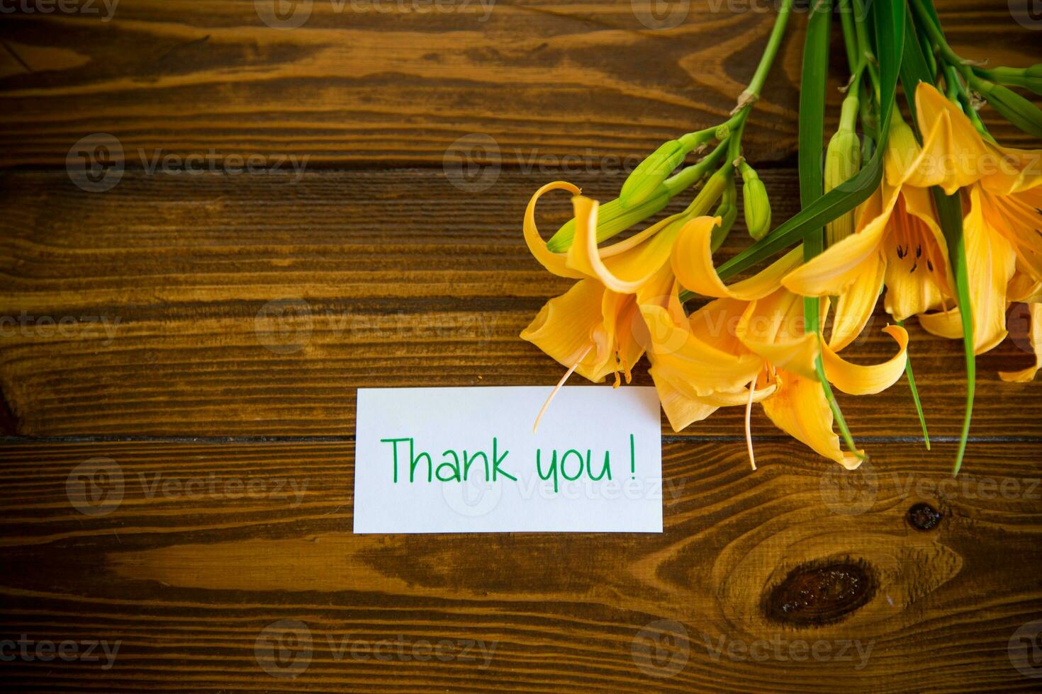 bouquet of beautiful yellow lilies on wooden table photo