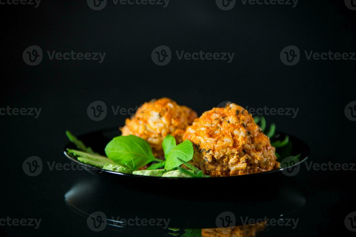 Cooked meatballs in a plate with fresh vegetables photo