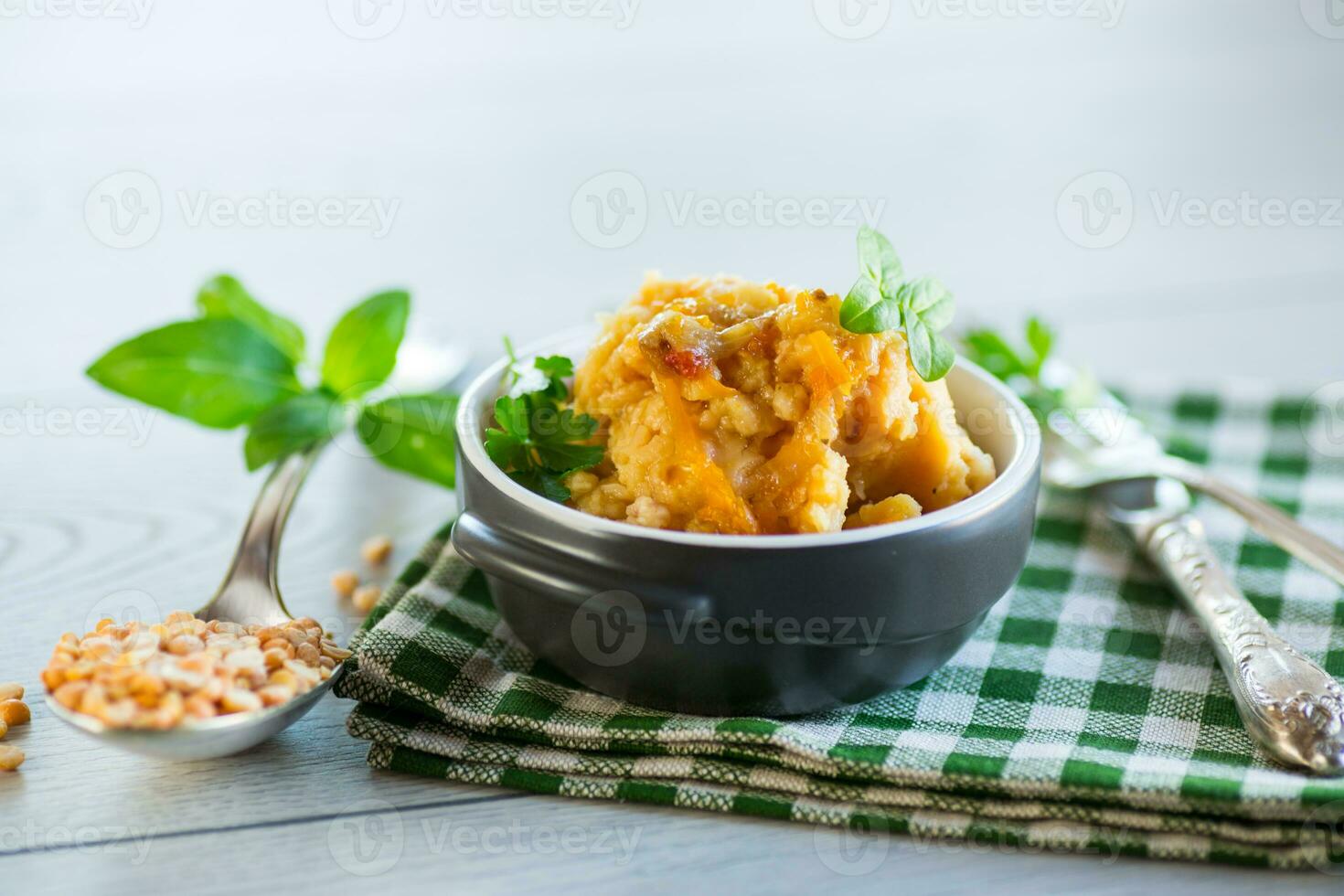 Cooked pea porridge with spices and seasonings in a ceramic bowl . photo