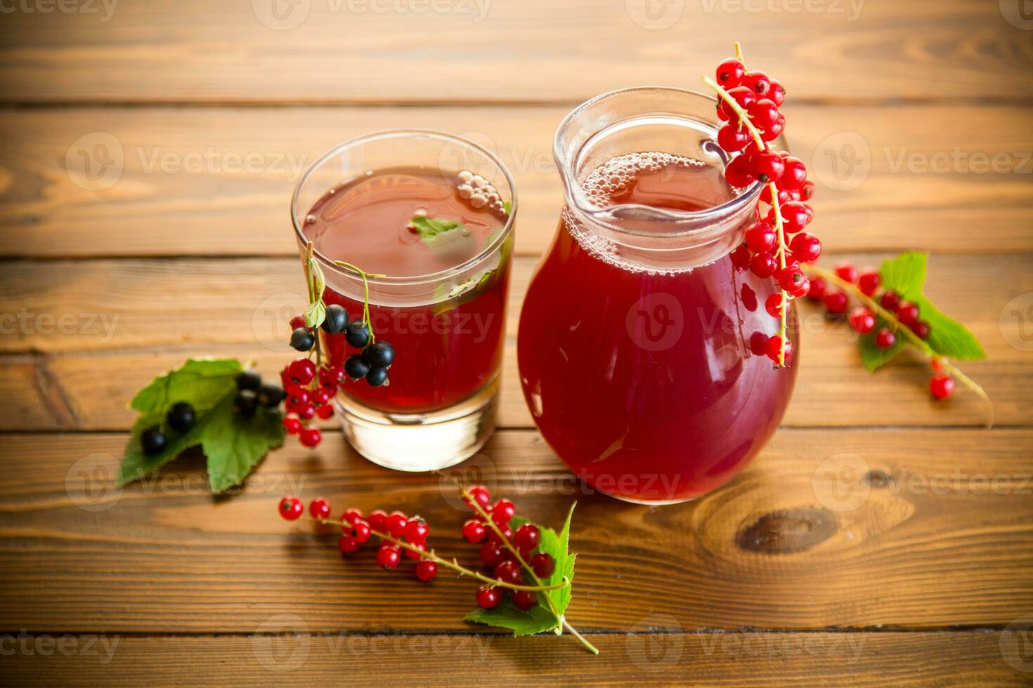 fresh berry juice from red and black currant, on a wooden table photo