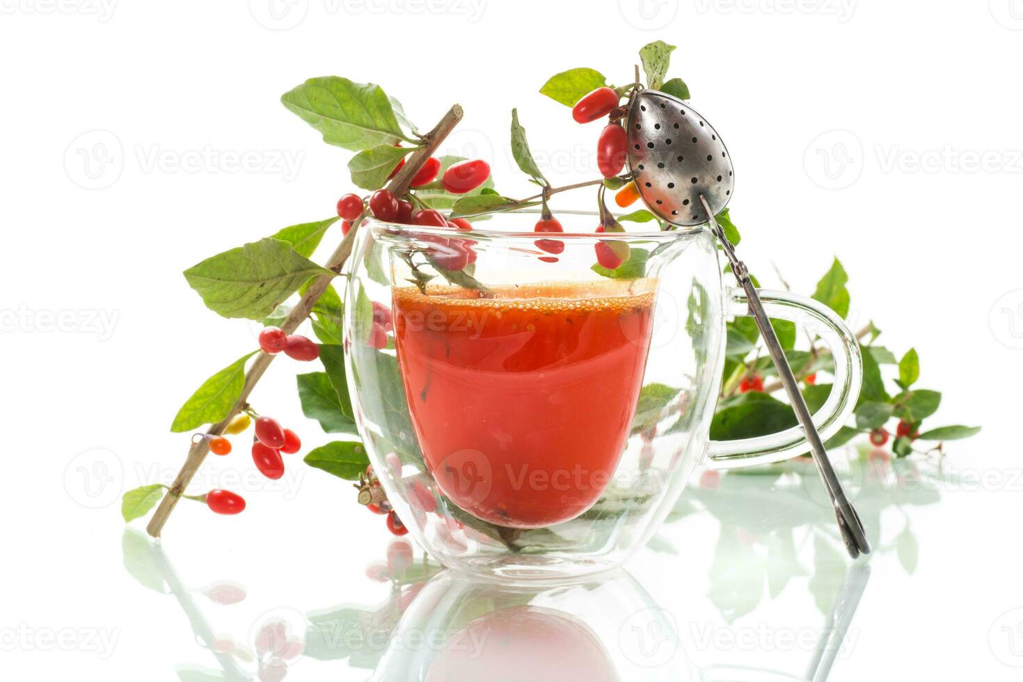 Prepared hot drink from ripe goji berries in a glass cup photo