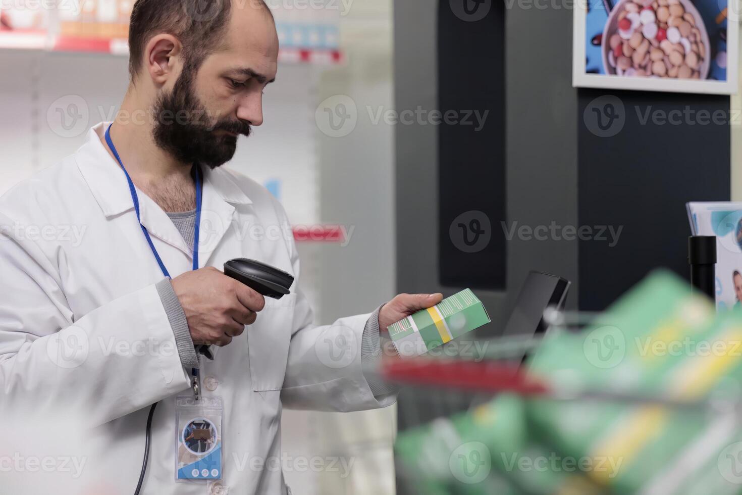 Pharmacist holding store scanner that reads the barcodes on all the pills and packages to ensure accuracy in dispensing medication. Drugstore employee working in pharmacy, checking supplements photo