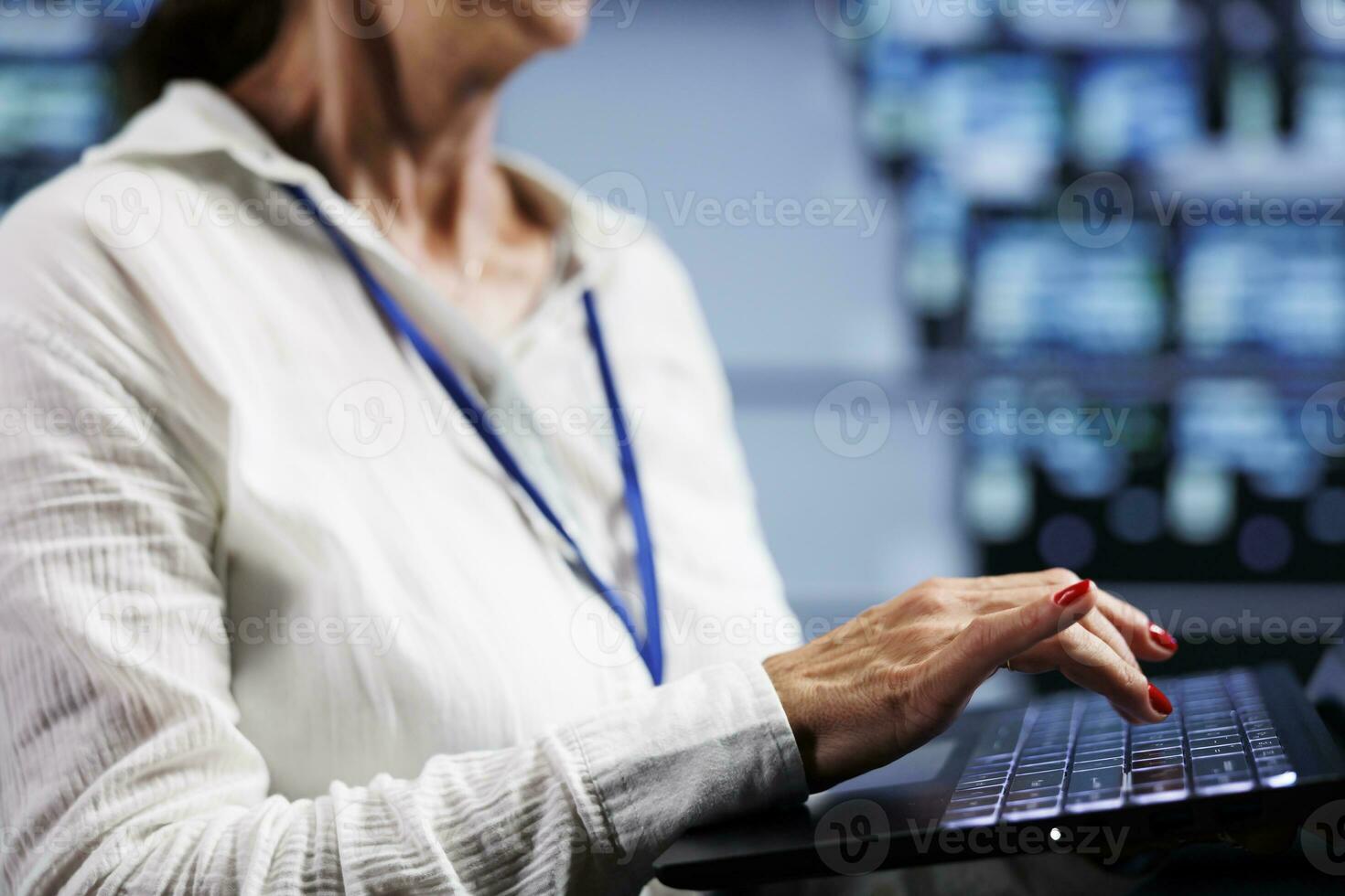 System admin working on laptop, setting up high bandwidth dedicated multiplayer gaming servers in high tech facility to accommodate more traffic from worldwide locations and avoid lag, close up photo