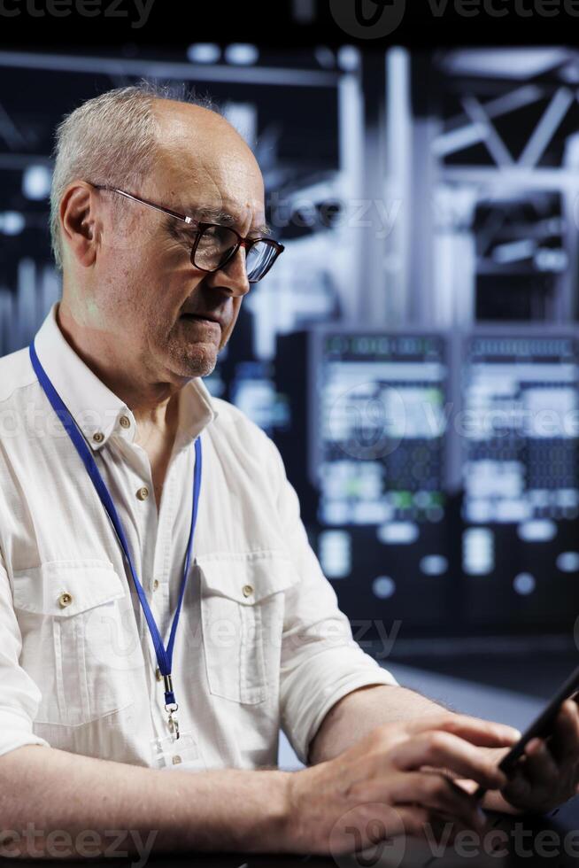 Elderly capable supervisor in data center providing dedicated VPN servers able to deliver encrypted sensitive data, augmented privacy, online anonymity and secure internet connections to users photo