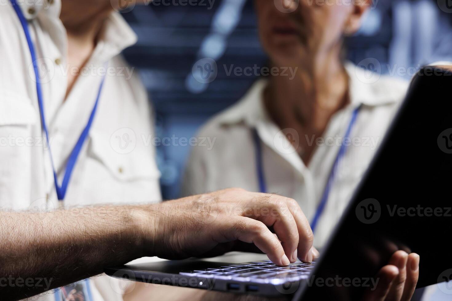 Old managers running analysis on server clusters helping businesses manage databases, host websites and store files. Knowledgeable computer scientists auditing high tech data center devices photo