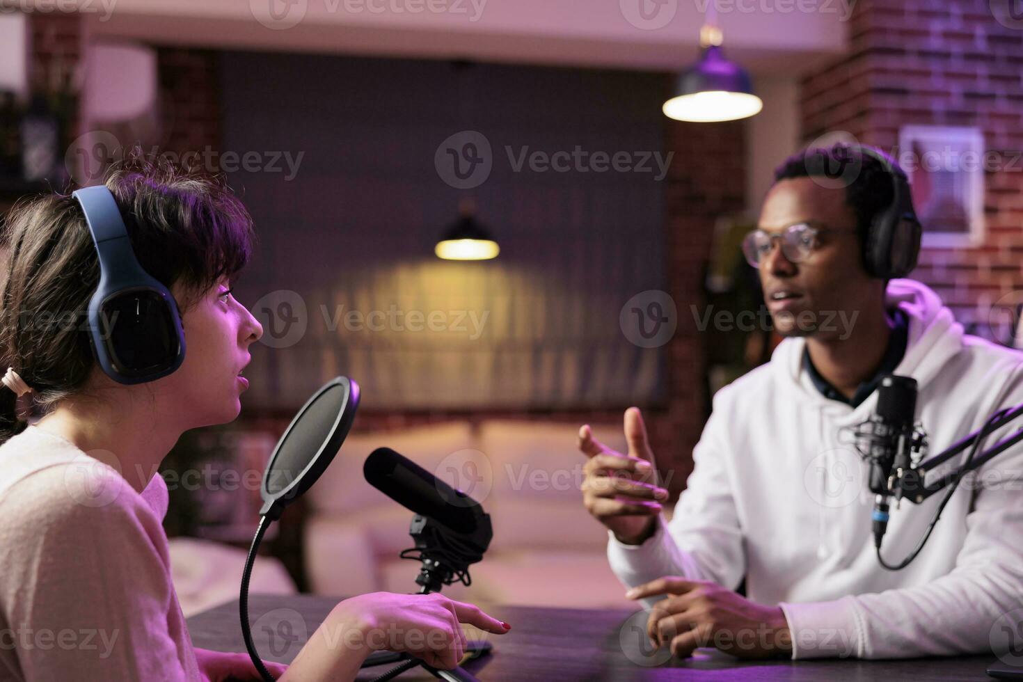 African american online show host chatting with guest during live broadcast for social media website, listening to her story. Internet celebrity using professional equipment to record podcast photo