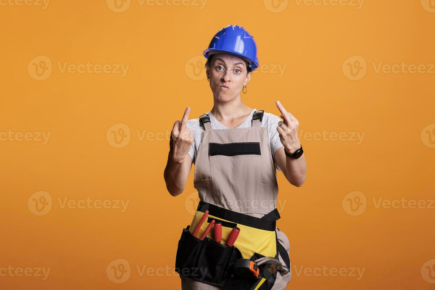 Bad construction worker showing middle finger photo