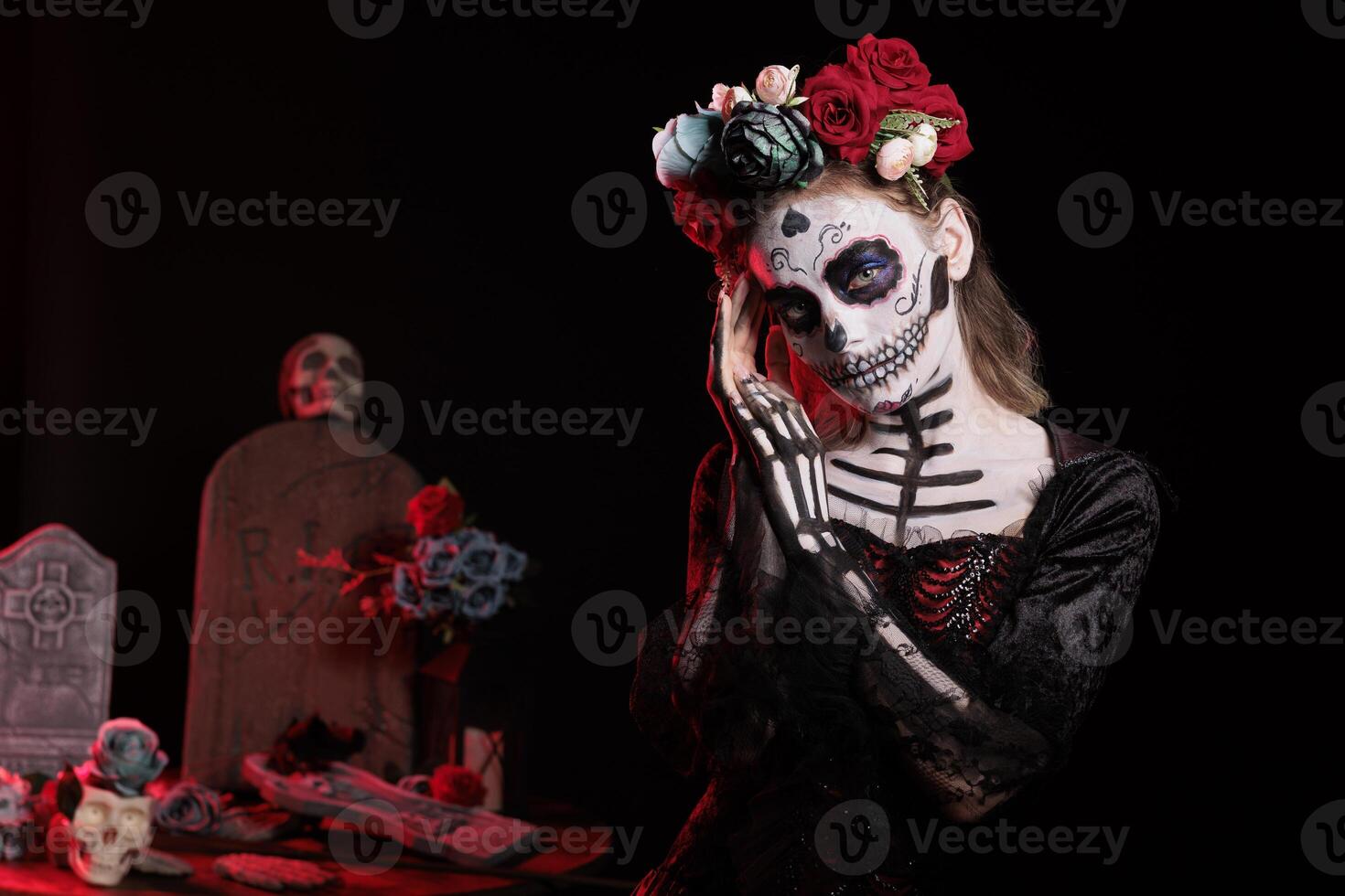 Lady of dead model with santa muerte costume looking like la cavalera catrina holy skull with make up. Wearing mexican halloween body art to celebrate dios de los muertos in studio. photo