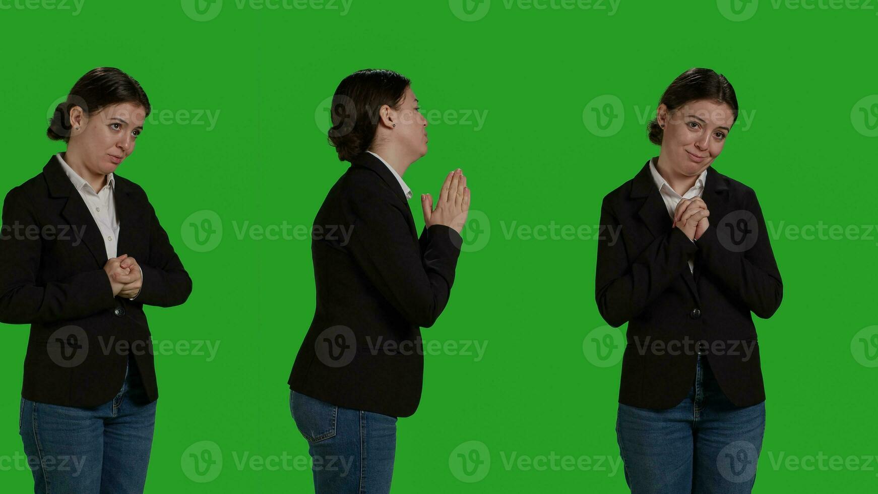 Close up of corporate employee doing prayer hands sign on camera, praying to god asking for luck. Spiritual religious person standing in silence over greenscreen backdrop, hope and belief. photo