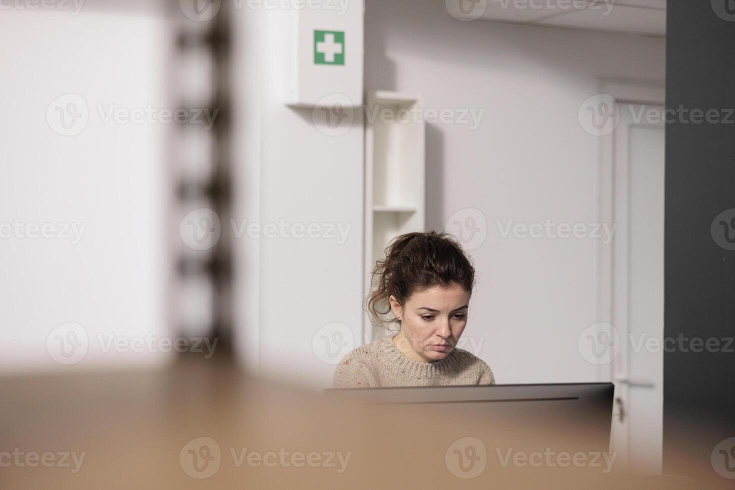 Warehouse manager standing at counter desk, analyzing merchandise logistics on computer. Storage room worker checking customers online orders preparing packages for shipping photo