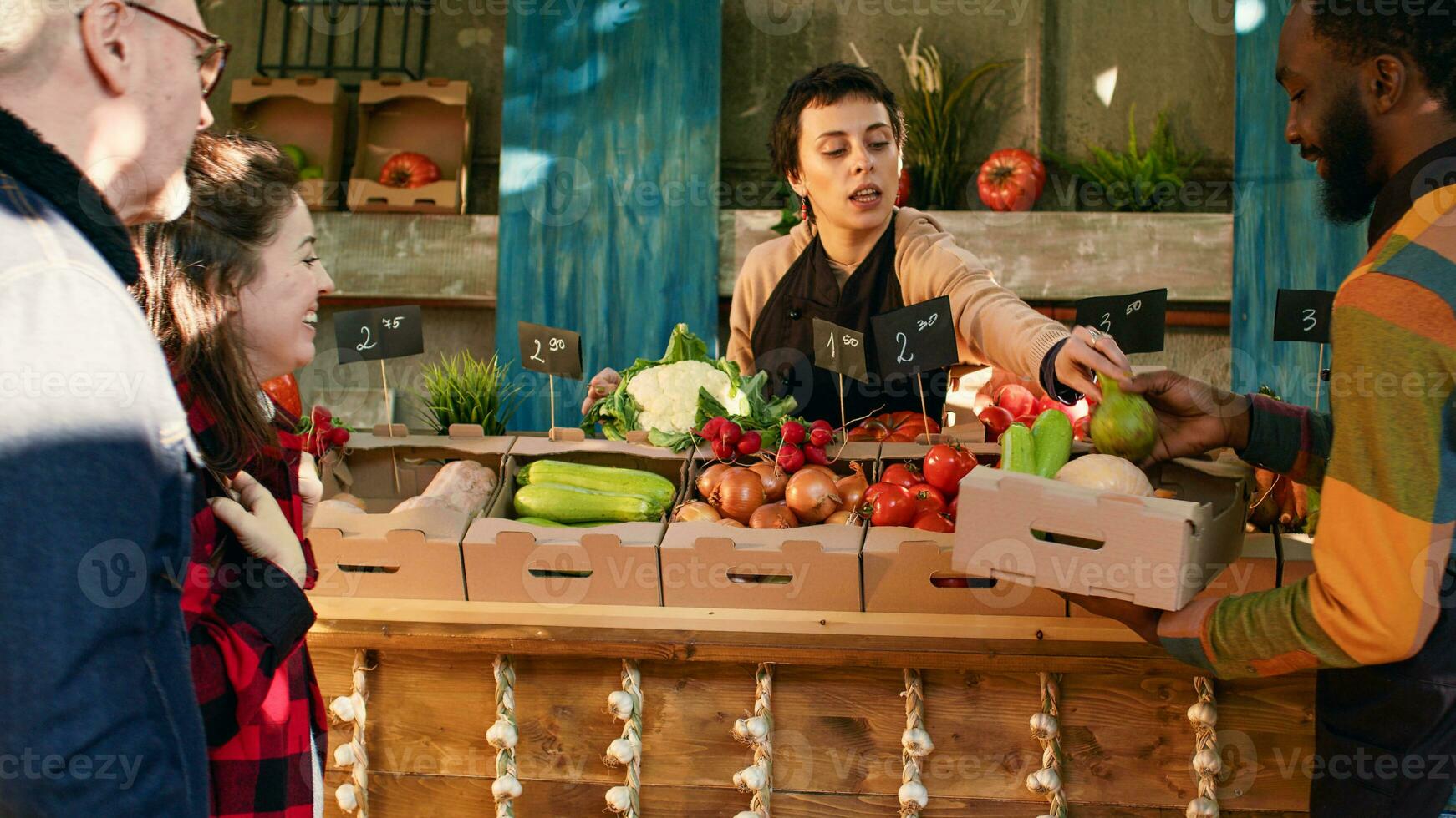 Small business owners helping clients with products and healthy food, vendors selling homegrown fruits and veggies. Customers talking to farmers about organic produce, stall holders. photo