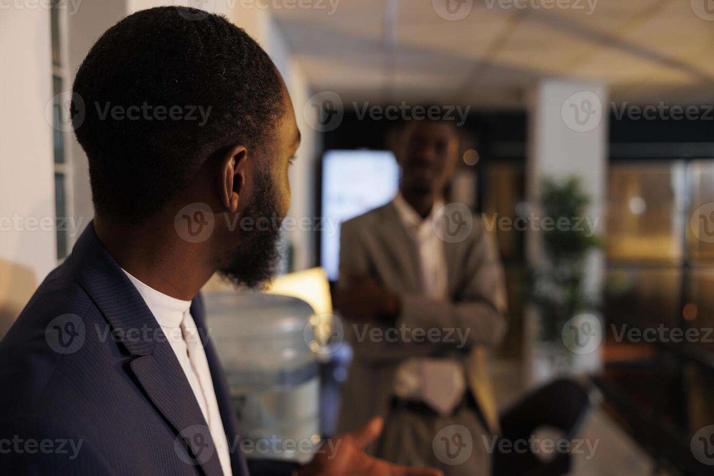 Manager explaining financial strategy to coworker during break time, team working overhours at company investment plan in startup office. Colleagues relaxing in workspace. Business concept photo