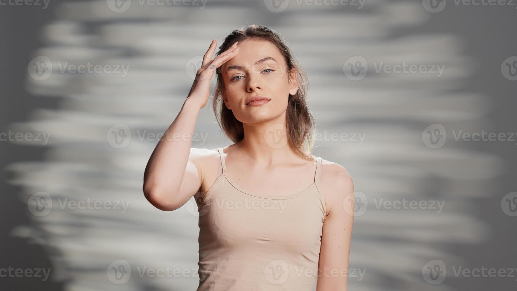 Caucasian female model applying facial cream for ad, creating skincare routine campaign with moisturizer and cosmetics. Beautiful woman with luminous bare skin promoting self confidence. photo