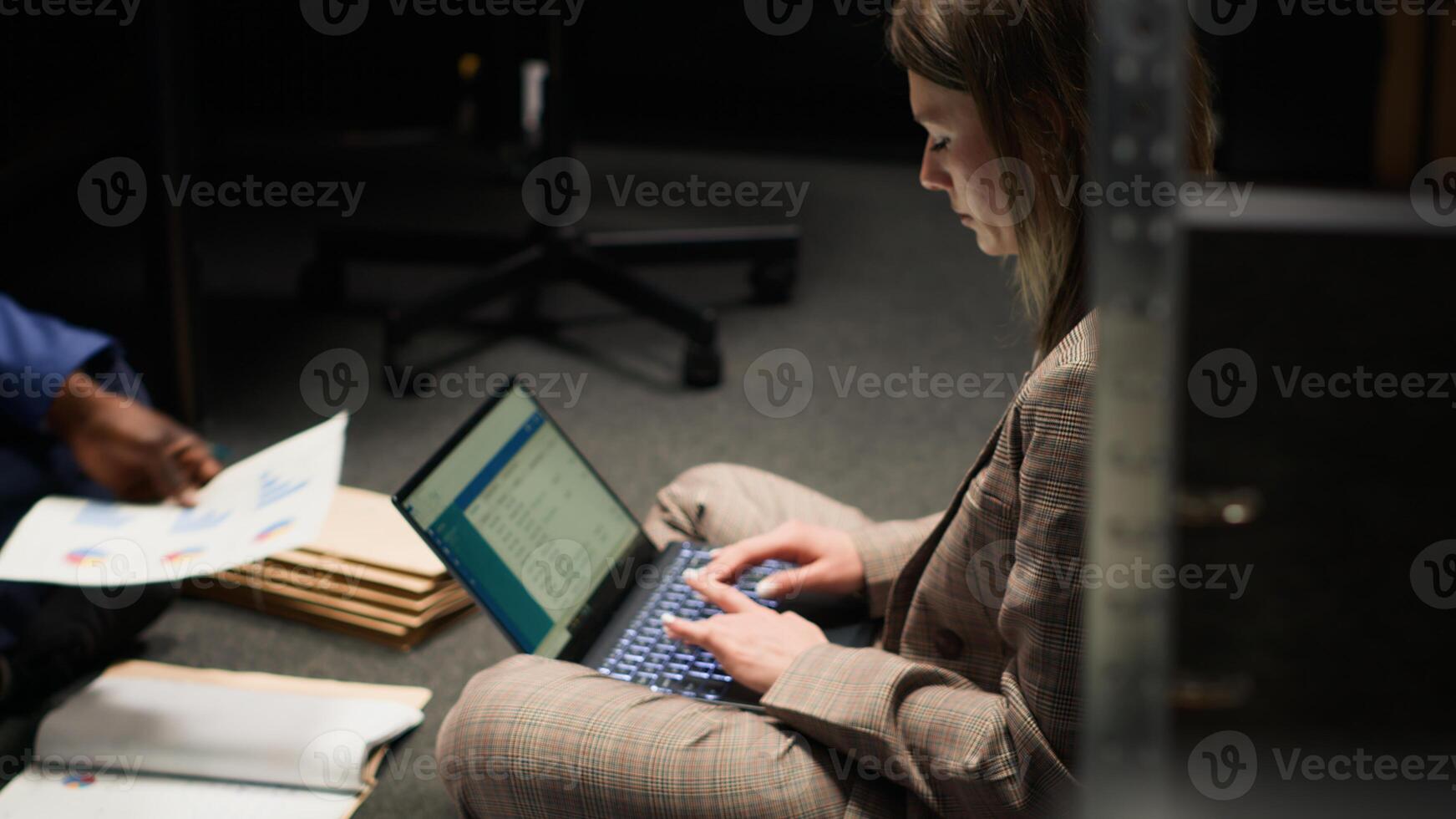 Focus on female private detective diligently using laptop in incident room, examining evidence and reviewing statements to solve complex case. Police officer thrilled for getting crucial information. photo