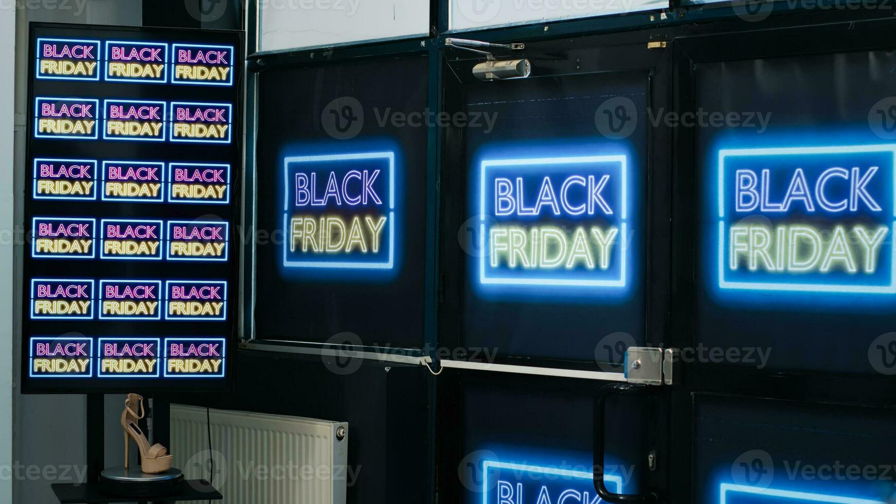 Entrance of clothing store with black friday signs, retail shop front door. Shopping center with fashion items hanging on racks, space decorated with promotions and discount banners. photo