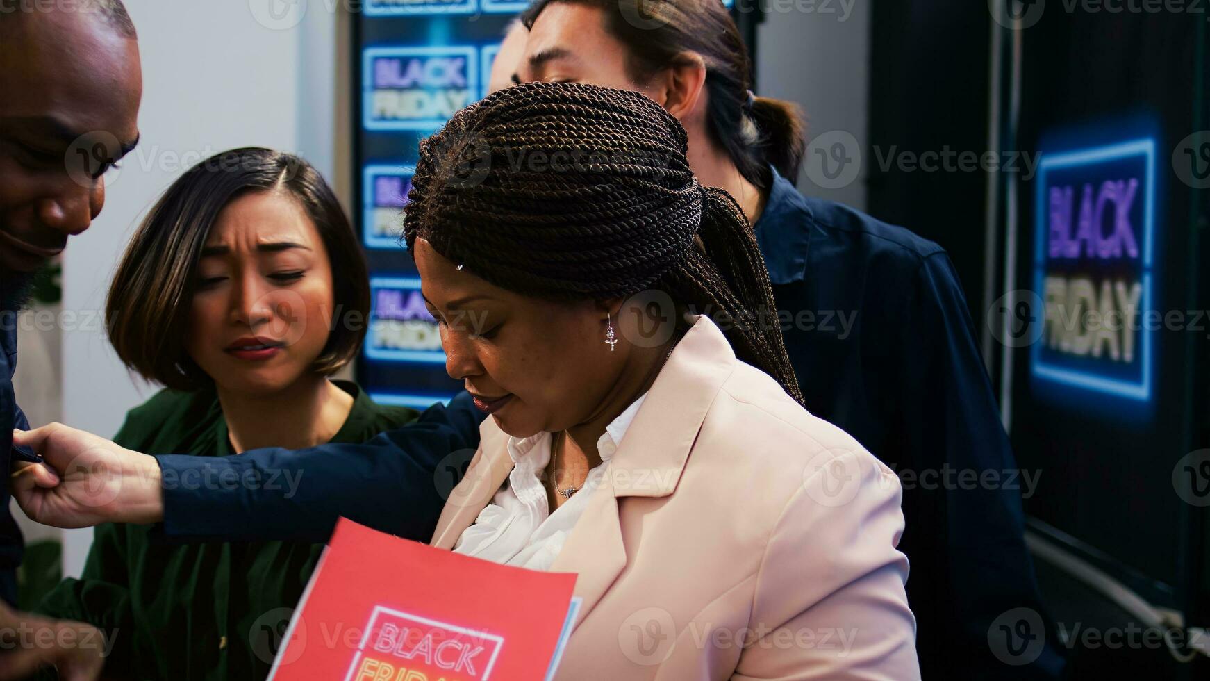 Mad diverse people at store entrance going crazy for black friday deals and promotions. African american security agent managing crowd control during seasonal sales at boutique. photo