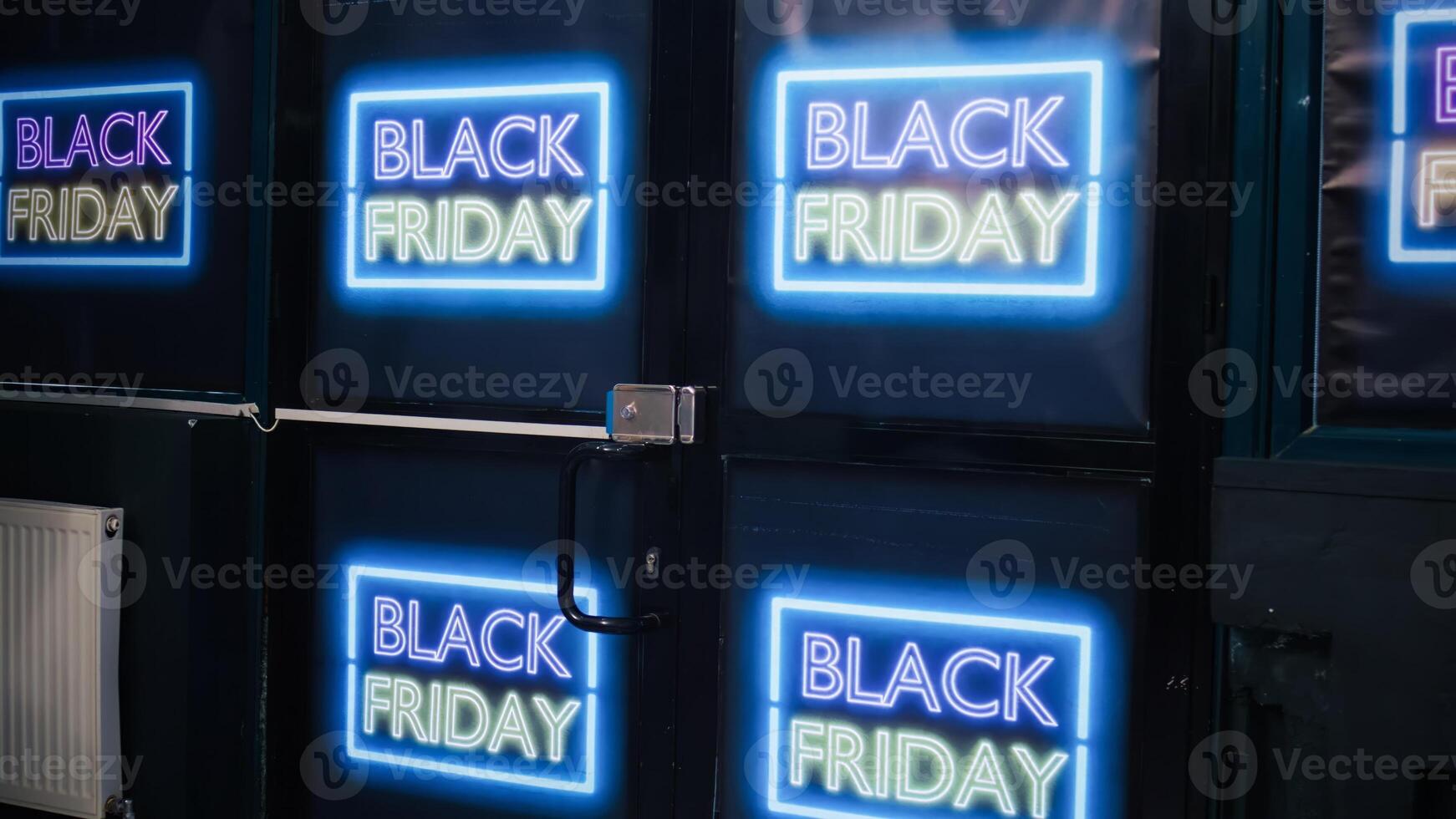 Store entrance decorated on black friday with neon signs, inside shopping center. Clothing shop interior with fashion items on racks, waiting for customers to buy products on shopping day. photo
