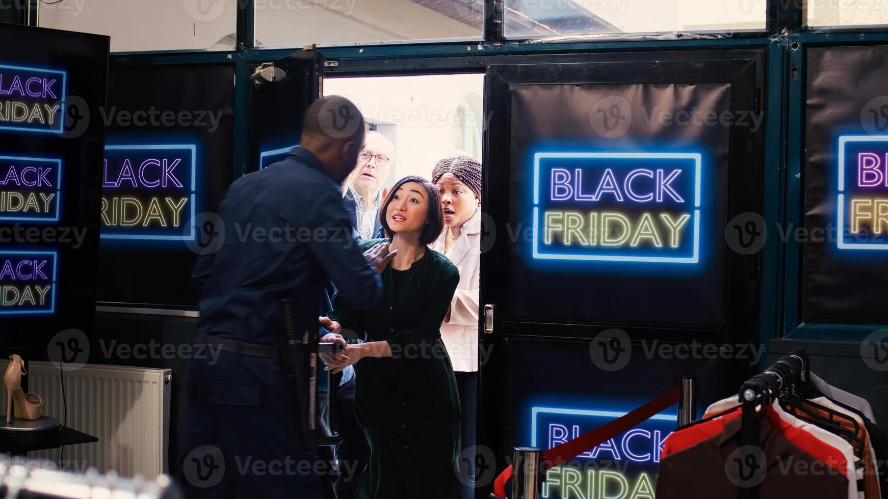 Obsessed customers going crazy in line to make black friday purchases, enjoying promotional prices and special offers. Furious aggressive shoppers running in shopping center, open doors. photo