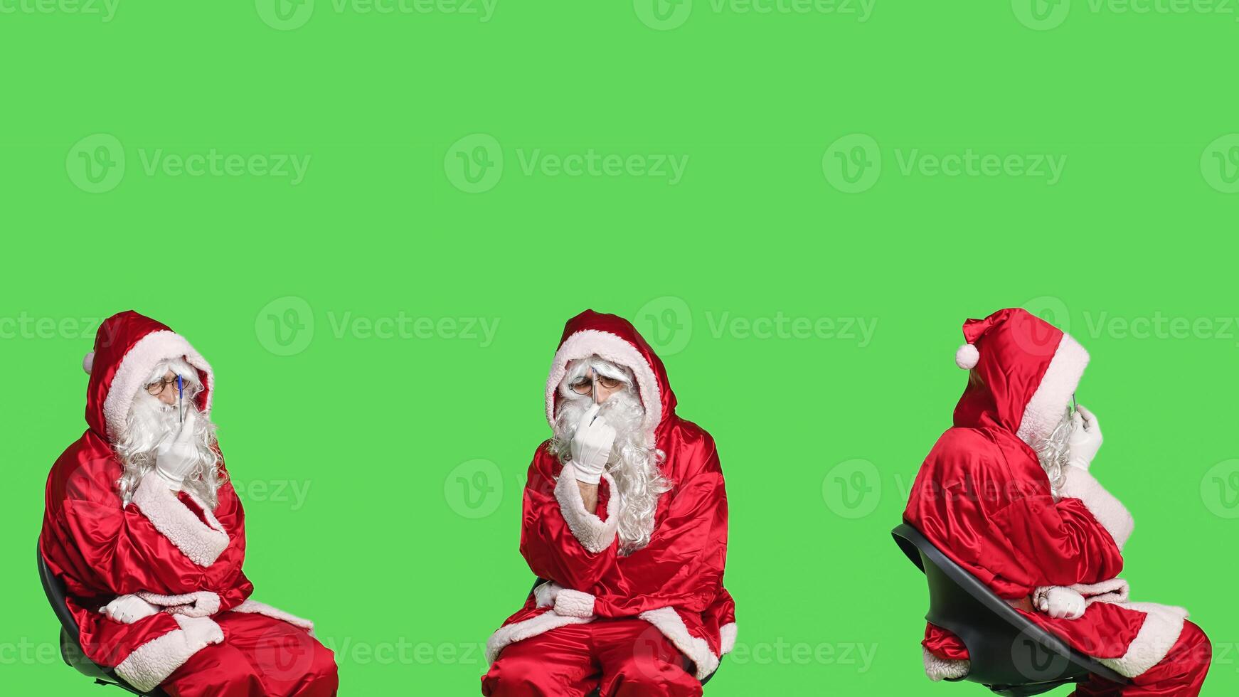 Seasonal character thinks about gifts, sitting on chair and brainstorming ideas for new presents on christmas eve. Santa claus in red costume acting pensive, preparing for winter holiday. photo