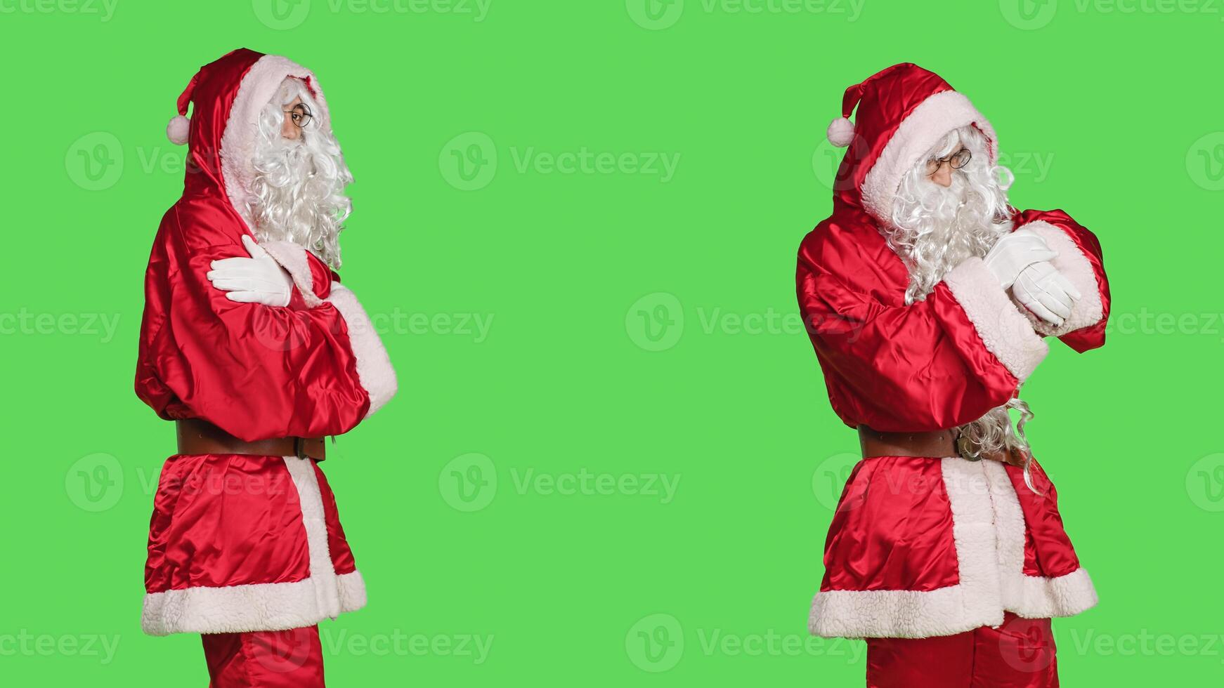 Model dressed like santa claus waiting, acting impatient over greenscreen backdrop in studio. Young man in traditional cosplay red costume acting festive, wait for something. photo