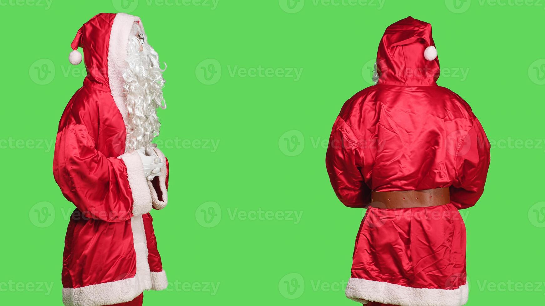 Man in santa claus costume posing and feeling cheerful about festive holiday, celebrating christmas eve over greenscreen backdrop. Joyful character marking seasonal winter celebration. photo