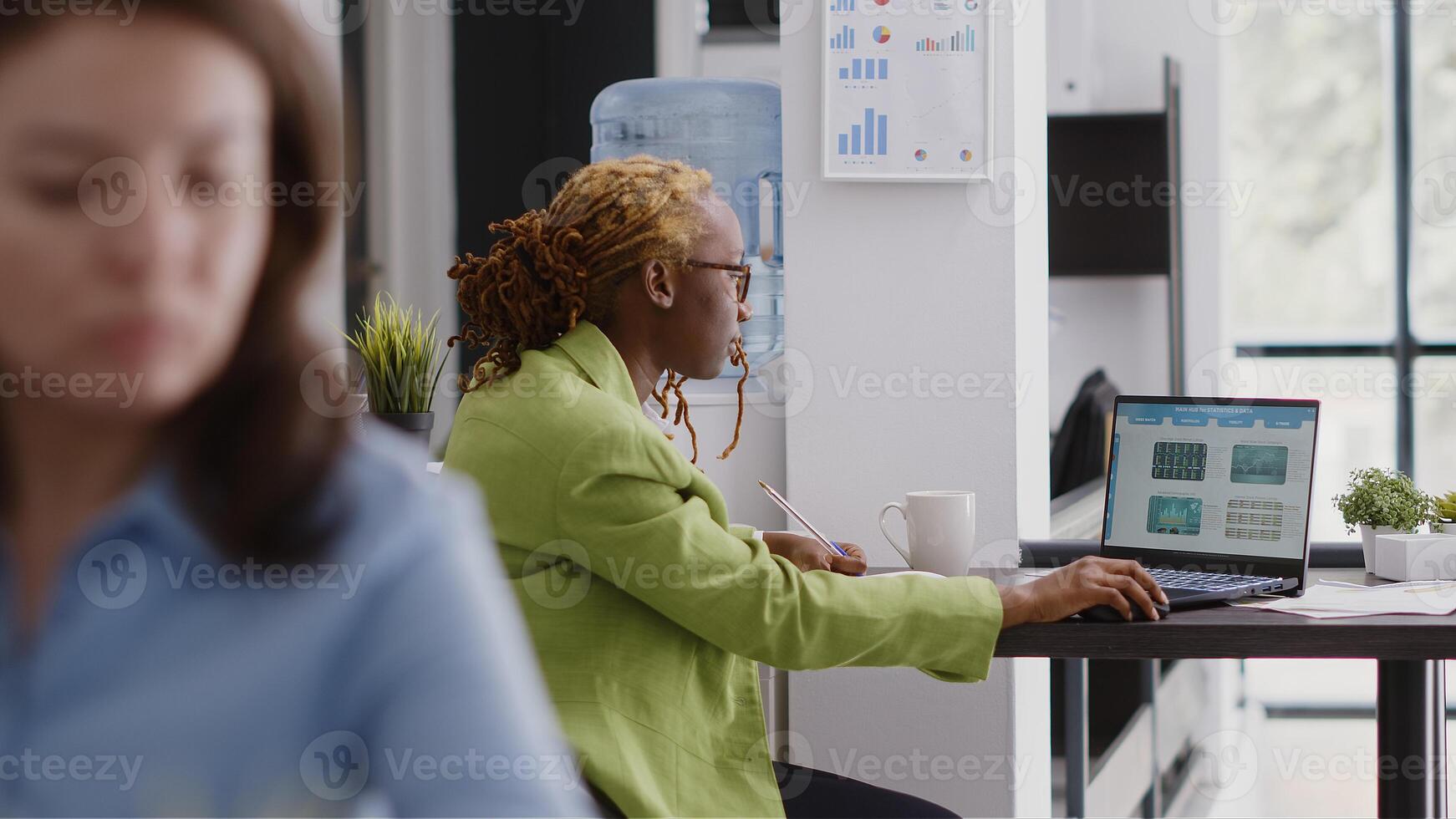 Female entrepreneur looking at online analytics on pc, planning new investment to increase profit. Young adult checking statistics to create annual data report, business growth in office. photo