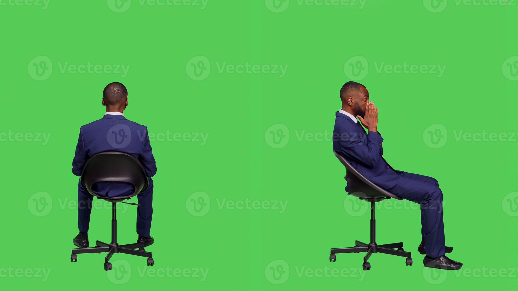 Young businessman sitting on chair and waiting, wearing formal office suit and posing over full body greenscreen backdrop. Male startup employee feeling optimistic in studio, stylish worker. photo