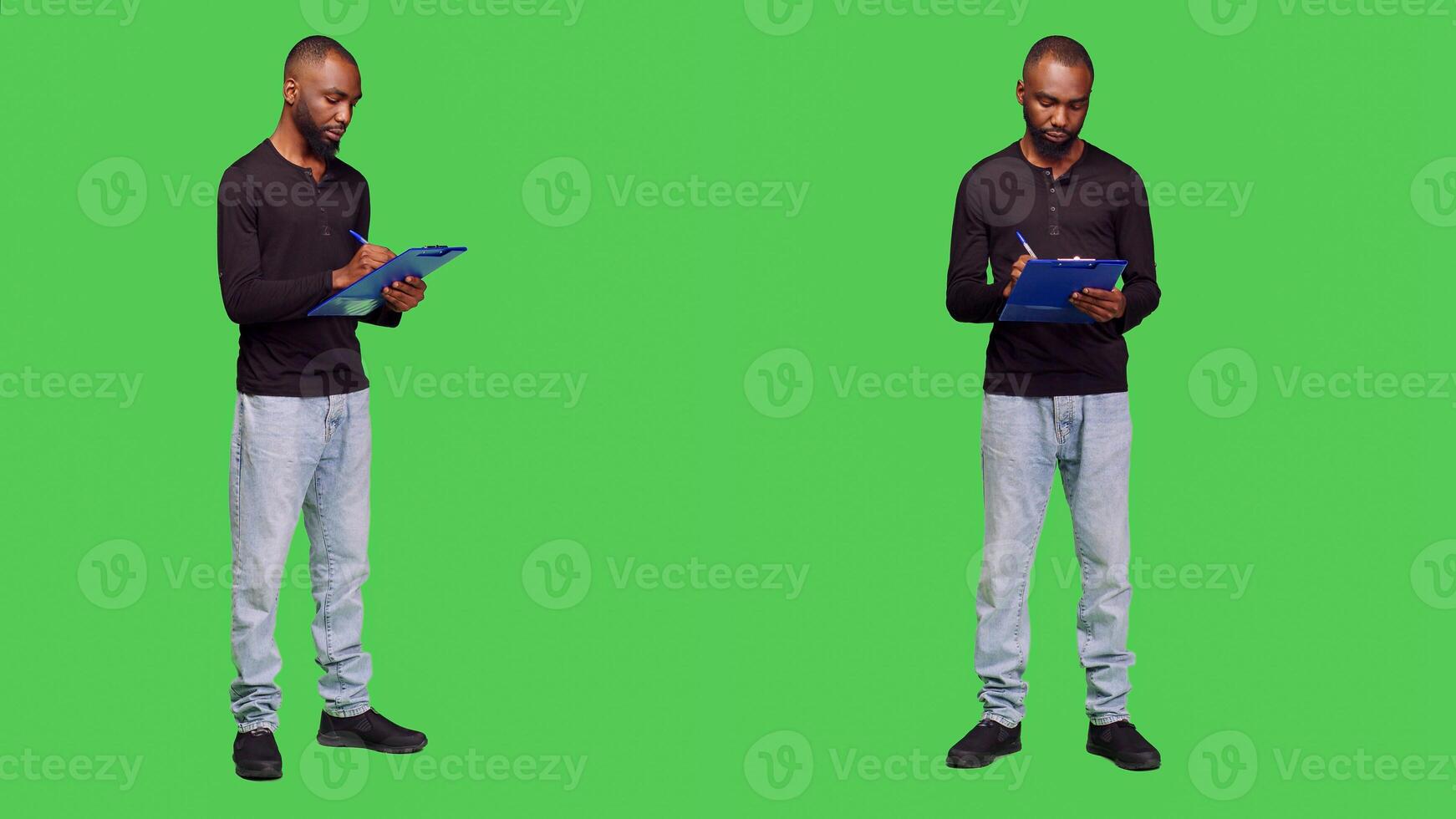 Male model taking notes on clipboard papers, standing over full body green screen. Young cheerful adult being positive on camera, writing information on files for leisure activity. photo