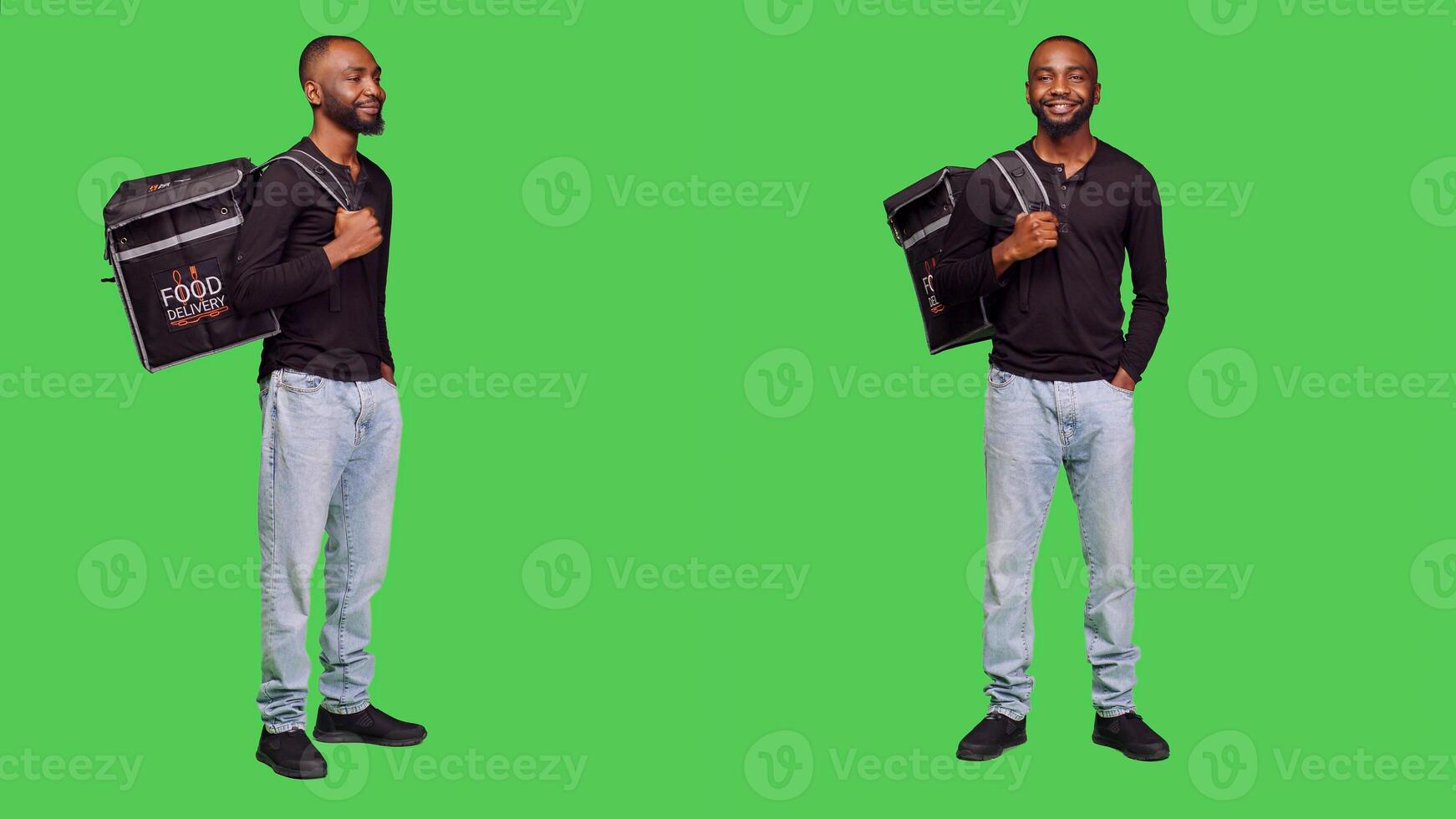 Young deliveryman carrying takeaway backpack, standing over full body greenscreen backdrop. African american guy delivering food order from takeout place, holding meal in thermal bag. photo
