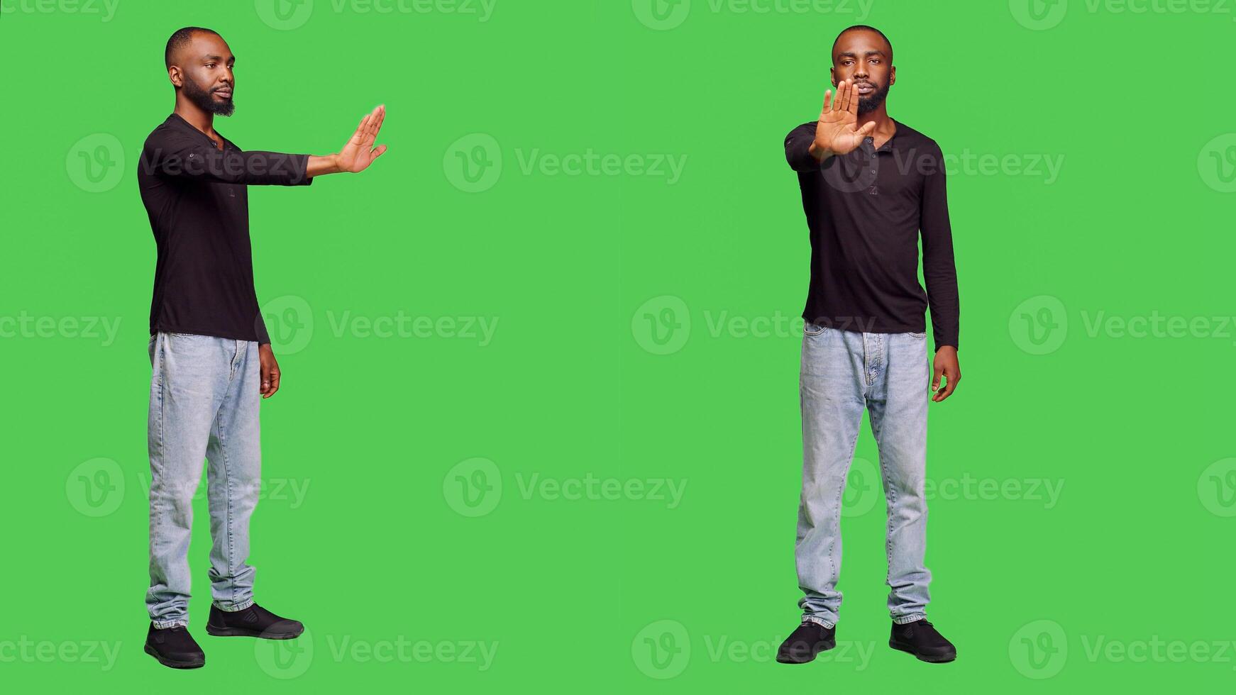 Negative person raising hand doing stop sign on camera, expressing rejection and denial. Young male adult being displeased and showing refusal gesture, no symbol on green screen. photo