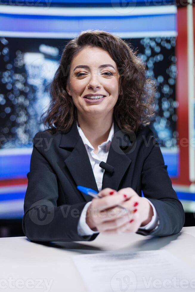 Journalist going live on night show in newsroom, discussing about latest incidents or daily scandals between celebrities. Presenter working on entertainment and media segment, cover newscast. photo