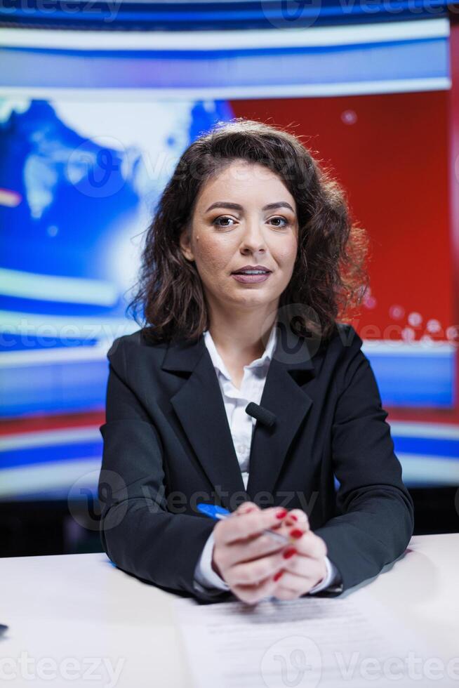 News reporter discussing latest events on live transmission, addressing all media subjects to create tv content. Woman presenter hosting breaking news section of daily reports, newsroom. photo