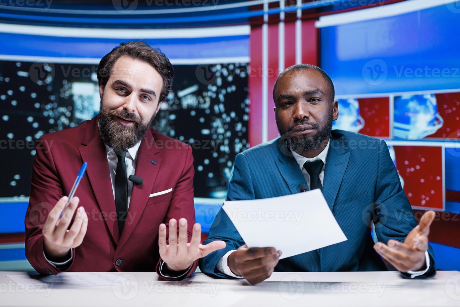 Newscasters reporting breaking news live on television night show, broadcasting global events with relevant information. Diverse team of presenters working in television media industry. photo