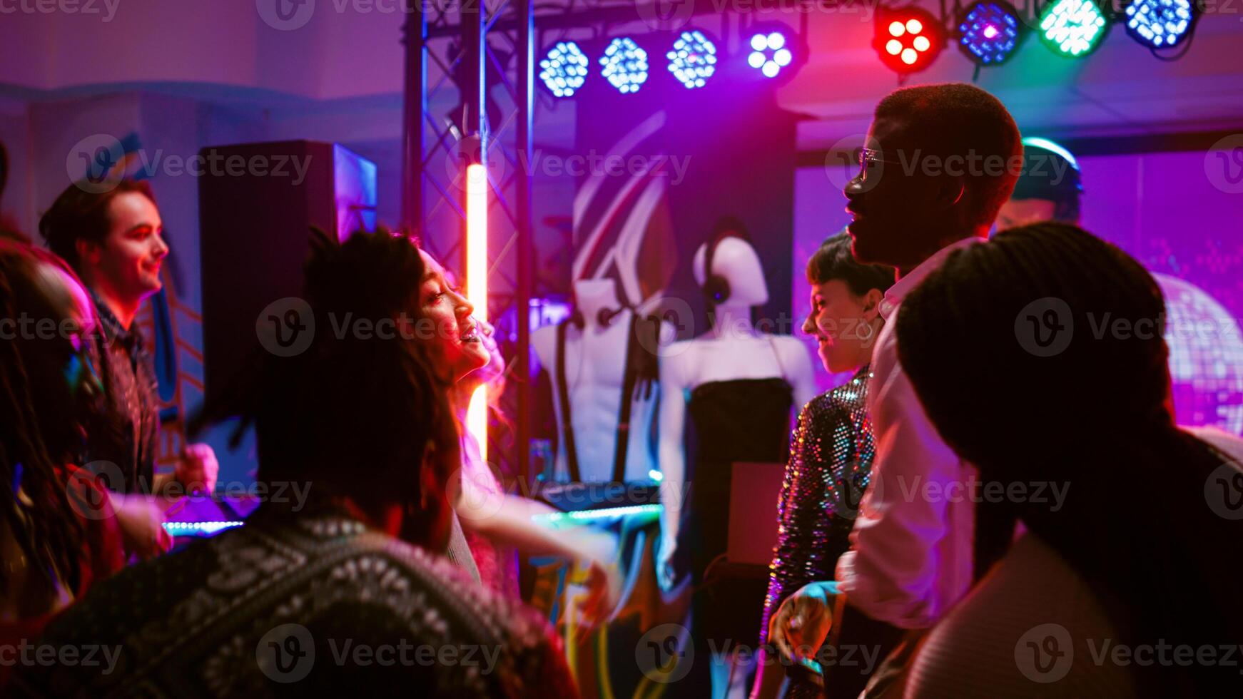 Diverse adults having fun at party showing dance moves on funky music, enjoying social gathering event. Men and women dancing on dance floor, feeling happy at discotheque. Handheld shot. photo