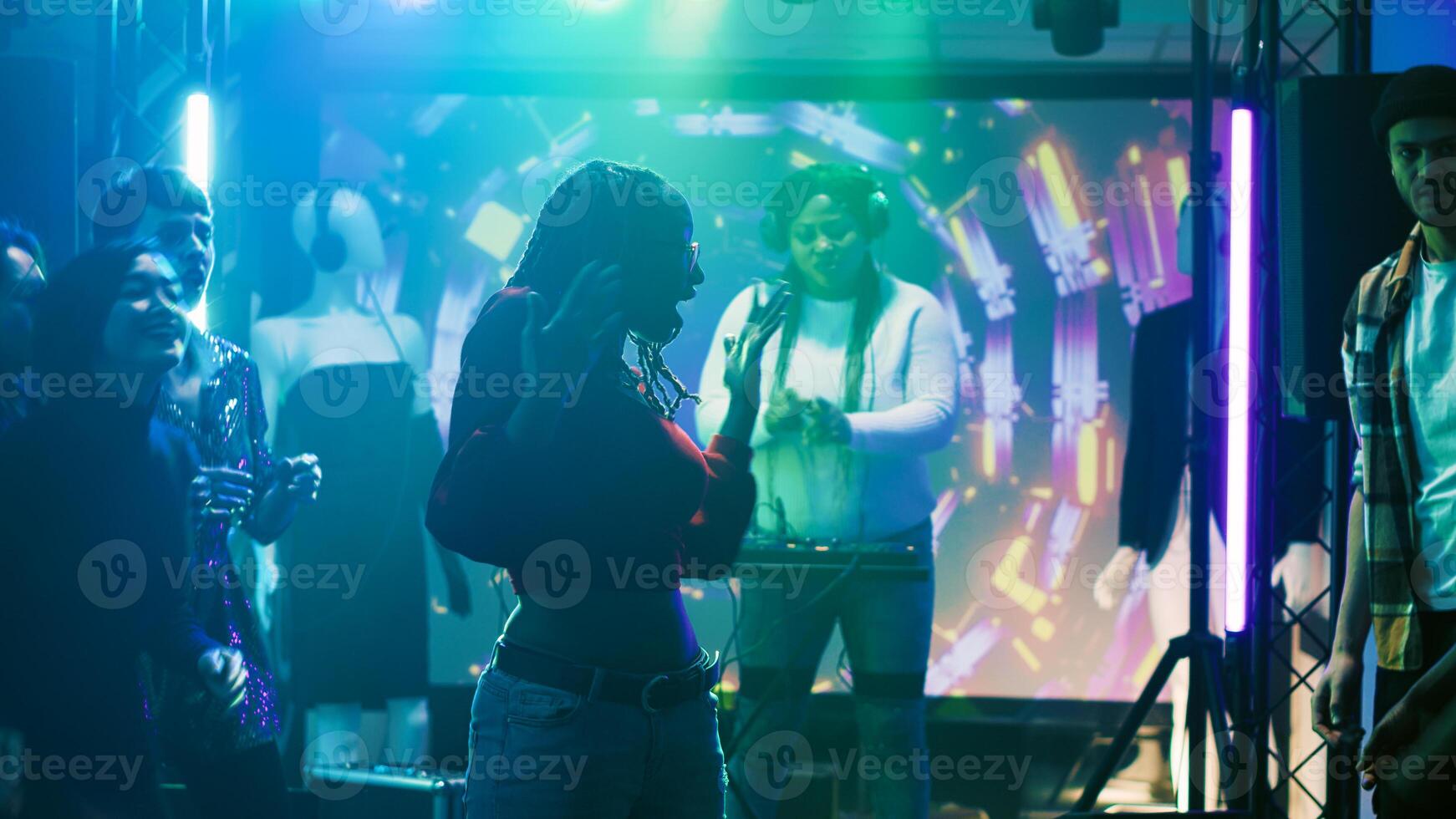 Young persons improvise dance battle and partying at nightclub, having fun with breakdance battle to show off skills. Group of friends enjoying dance party in modern discotheque. Tripod shot. photo