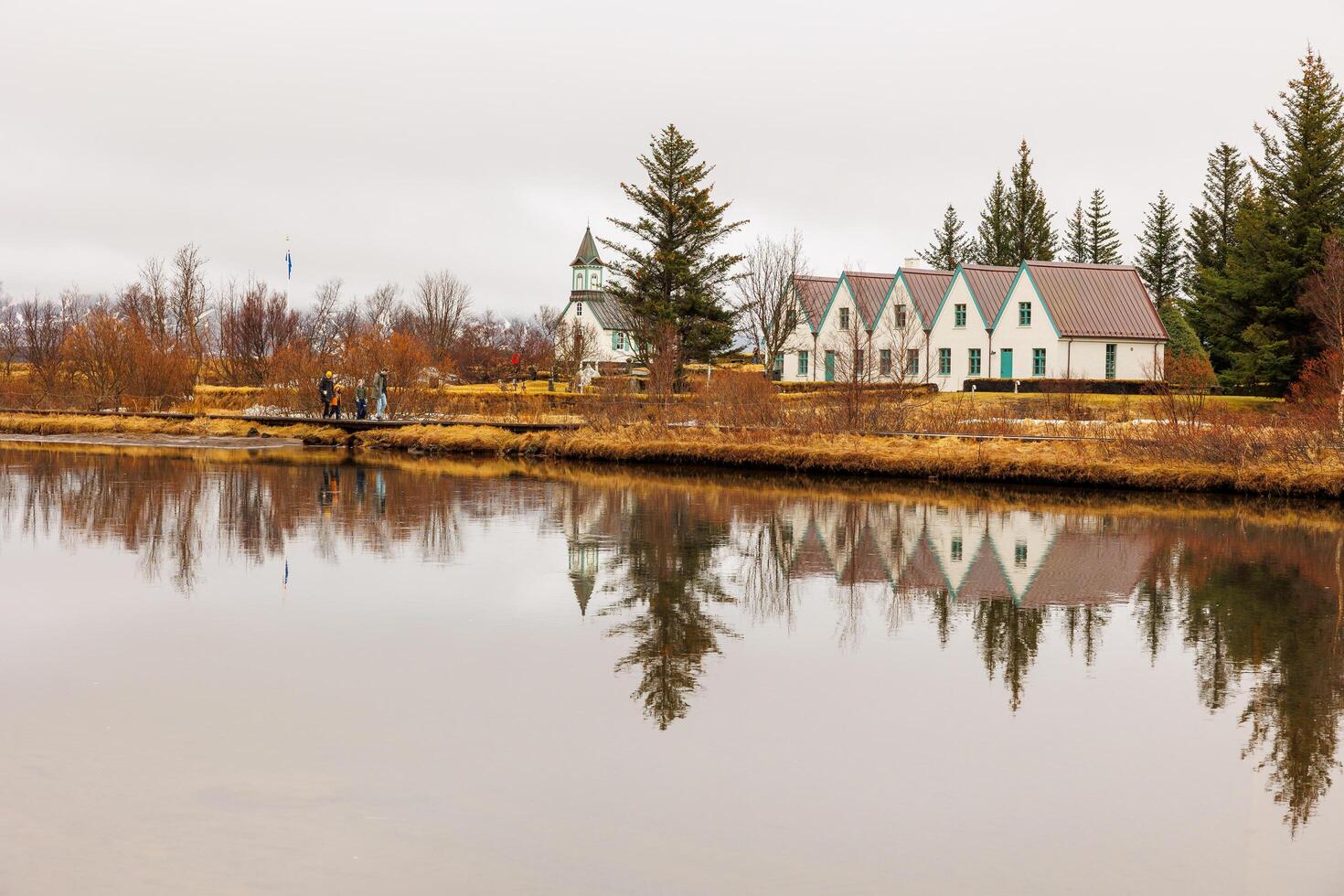 Thingvellir national park with travellers circa March 2023 in reykjavik capital, people enjoying walk in icelandic mountain park. Tourists hiking in nordic countryside scenery, golden circle. photo