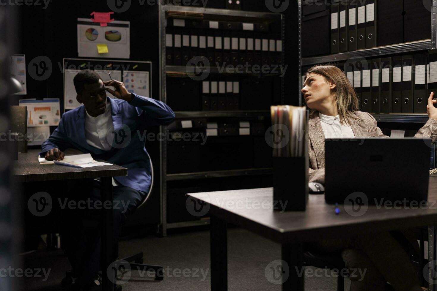 Diverse employees working at management research, searching for bureaucracy record in storage room. Businesspeople analyzing accountancy report, checking administrative documents photo