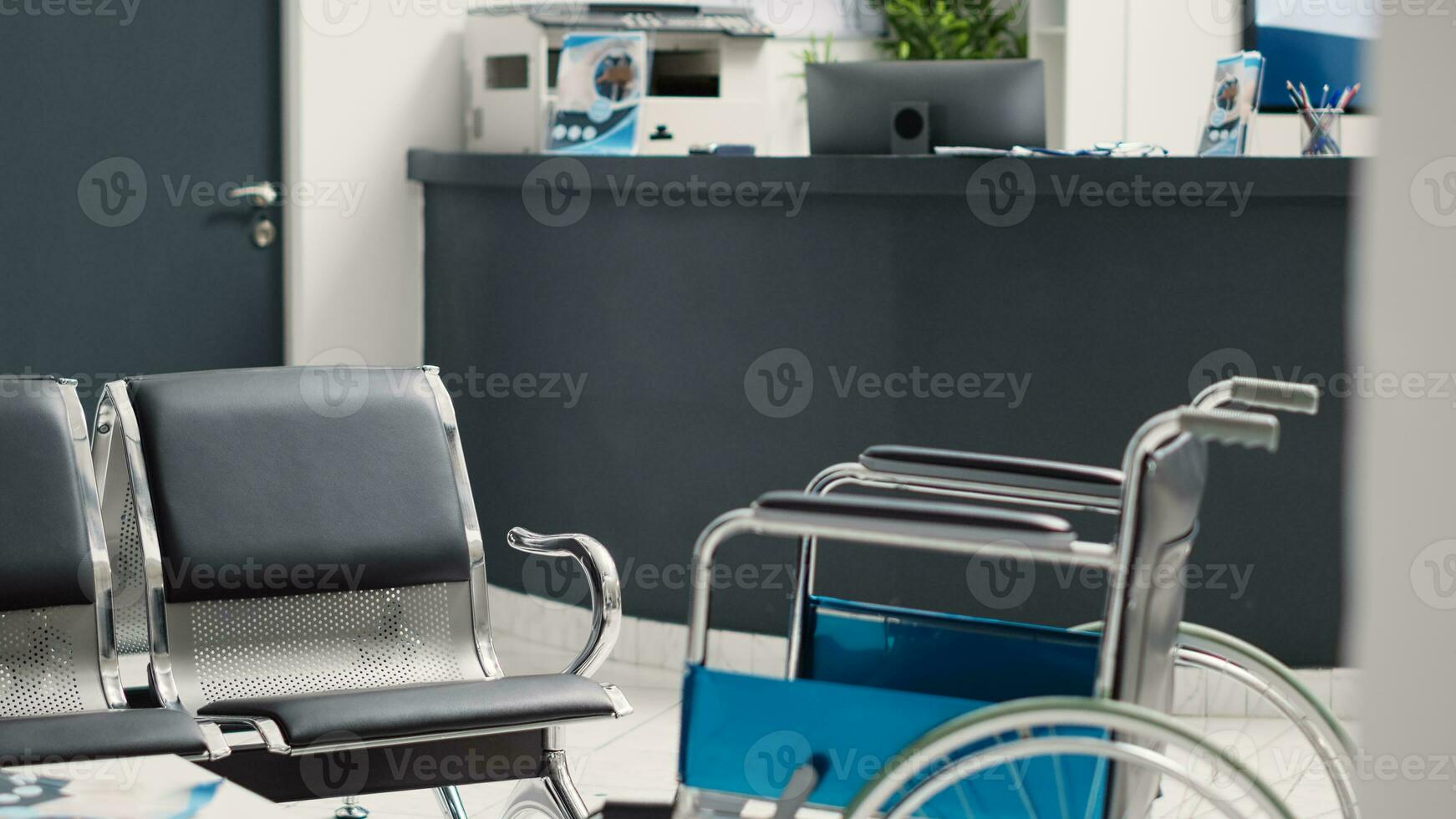 Empty medical facility counter with wheelchair and seats, medical checkup report to help with health care insurance. Disability friendly clinic lobby used for clinical appointments. photo