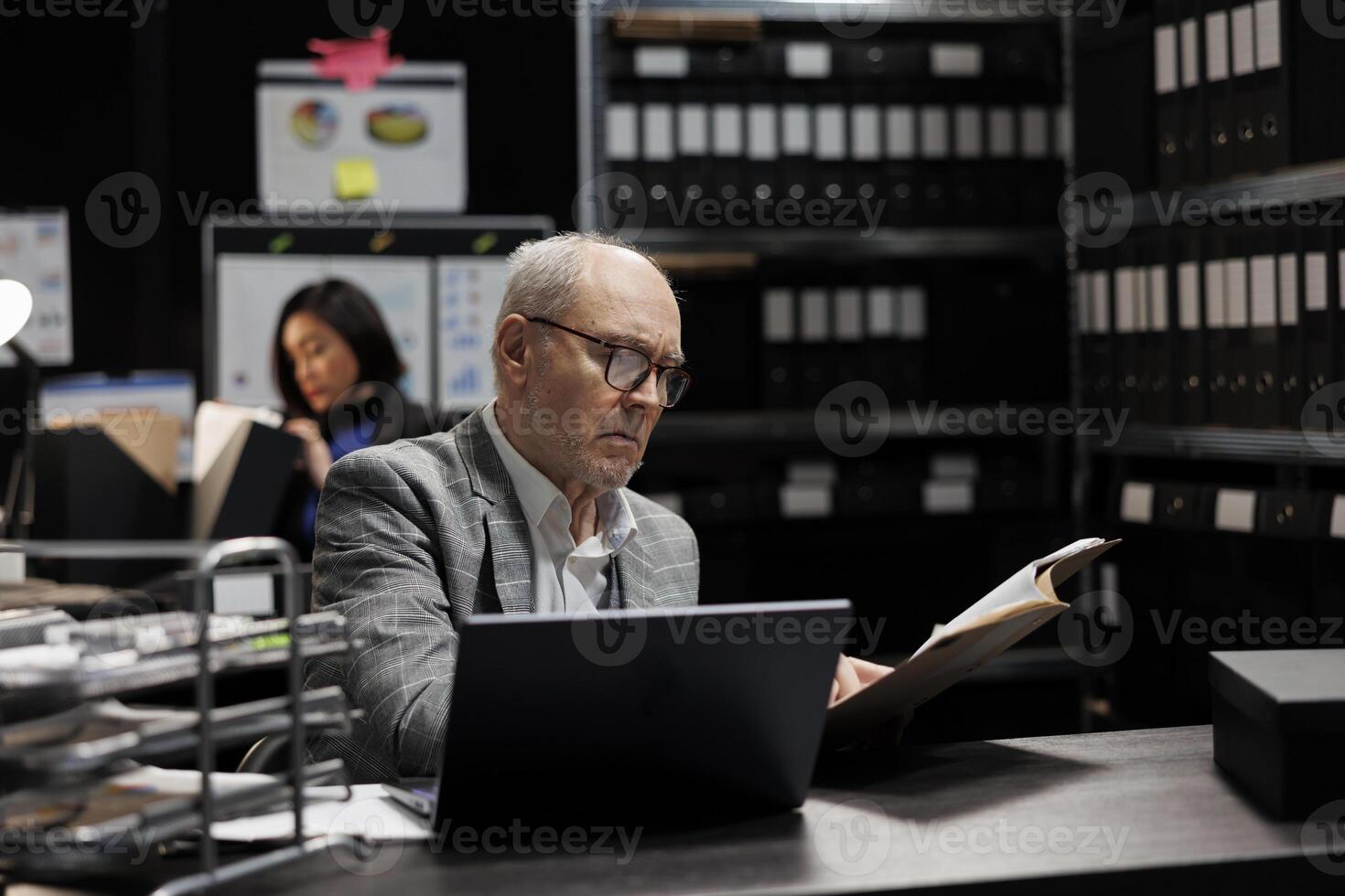 Senior businessman executive checking accountancy budget plan data paperwork. Bureaucratic administration employees in depository filled with document folders and flowchart reports photo