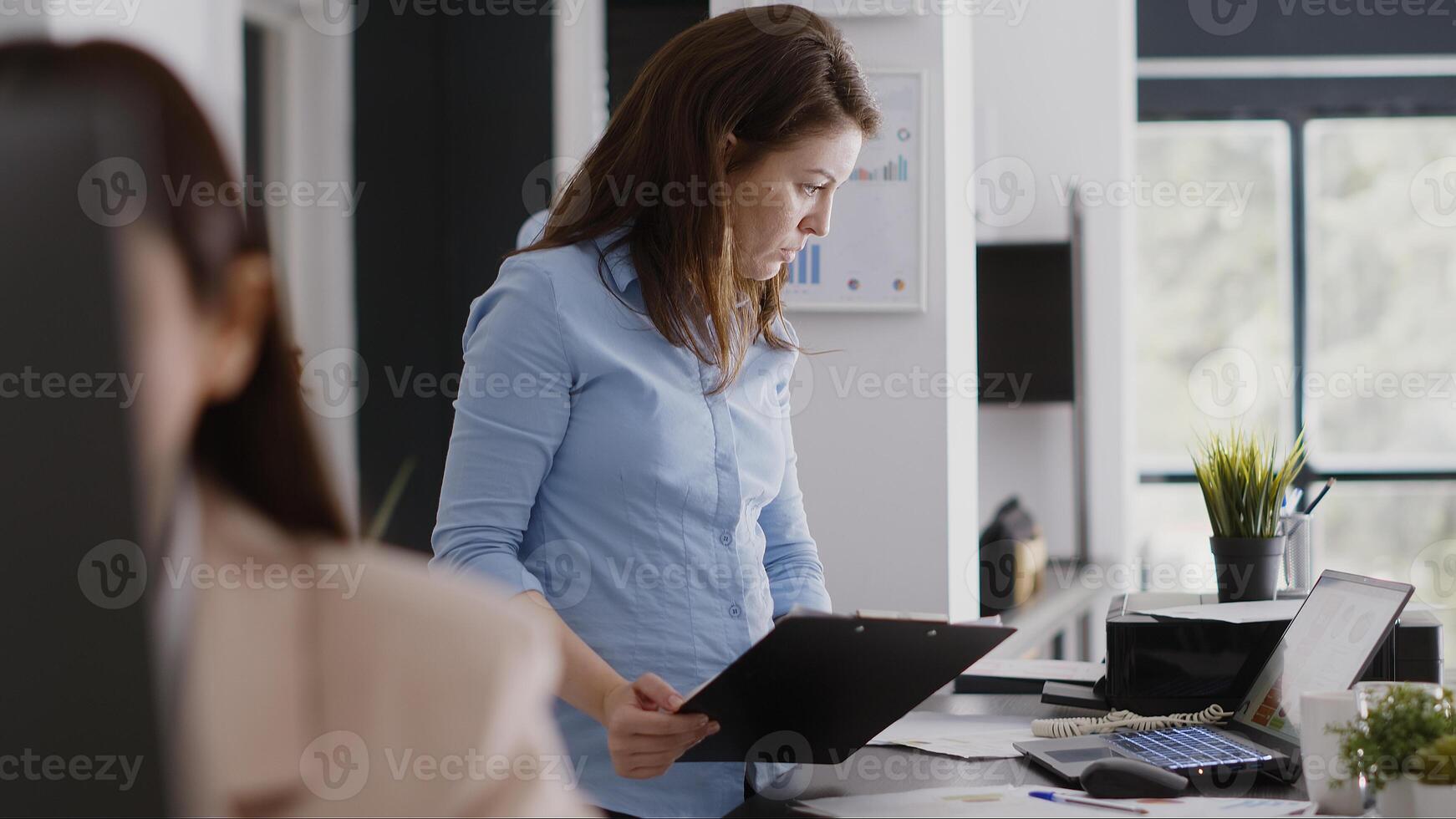 Professional employee analyzing company data on files, working with investment plan for successful growth. Female worker checking analytics and statistics on papers, annual report. photo