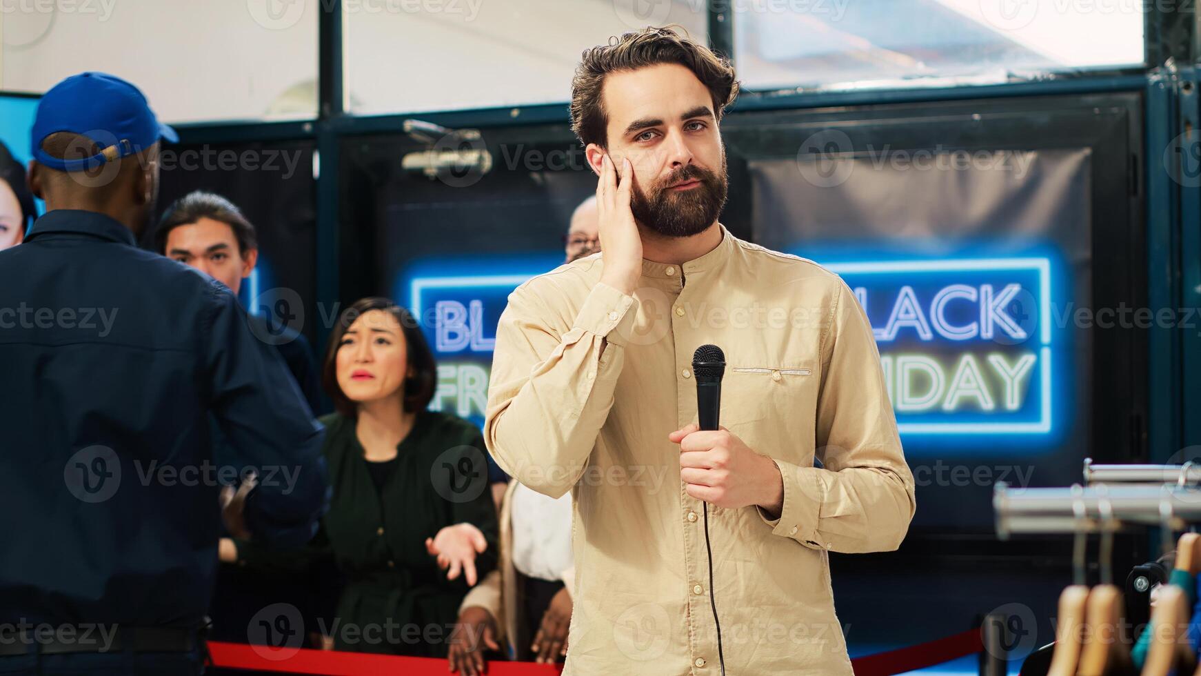 TV journalist broadcast live news about black friday event madness. Man reporter filming reportage at local shopping center to catch crazy obsessed people breaking the line. Tripod shot. photo