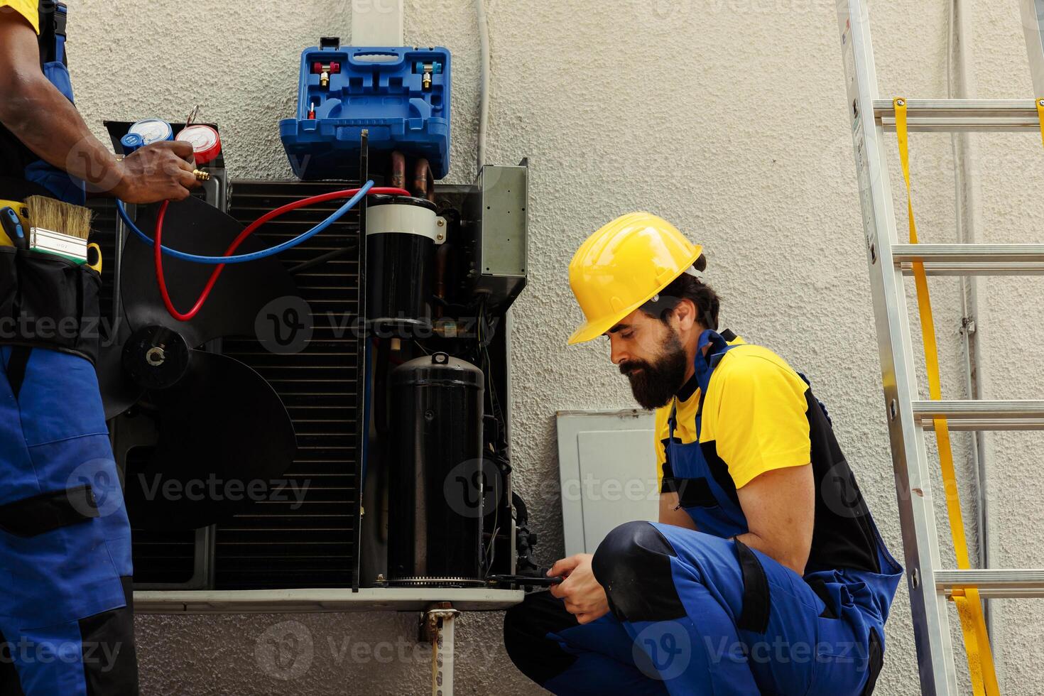 Experts fixing defective blower fan causing frozen evaporator coil, resulting in poor airflow. Knowledgeable professionals optimizing HVAC system, ensuring it operates at maximum performance photo
