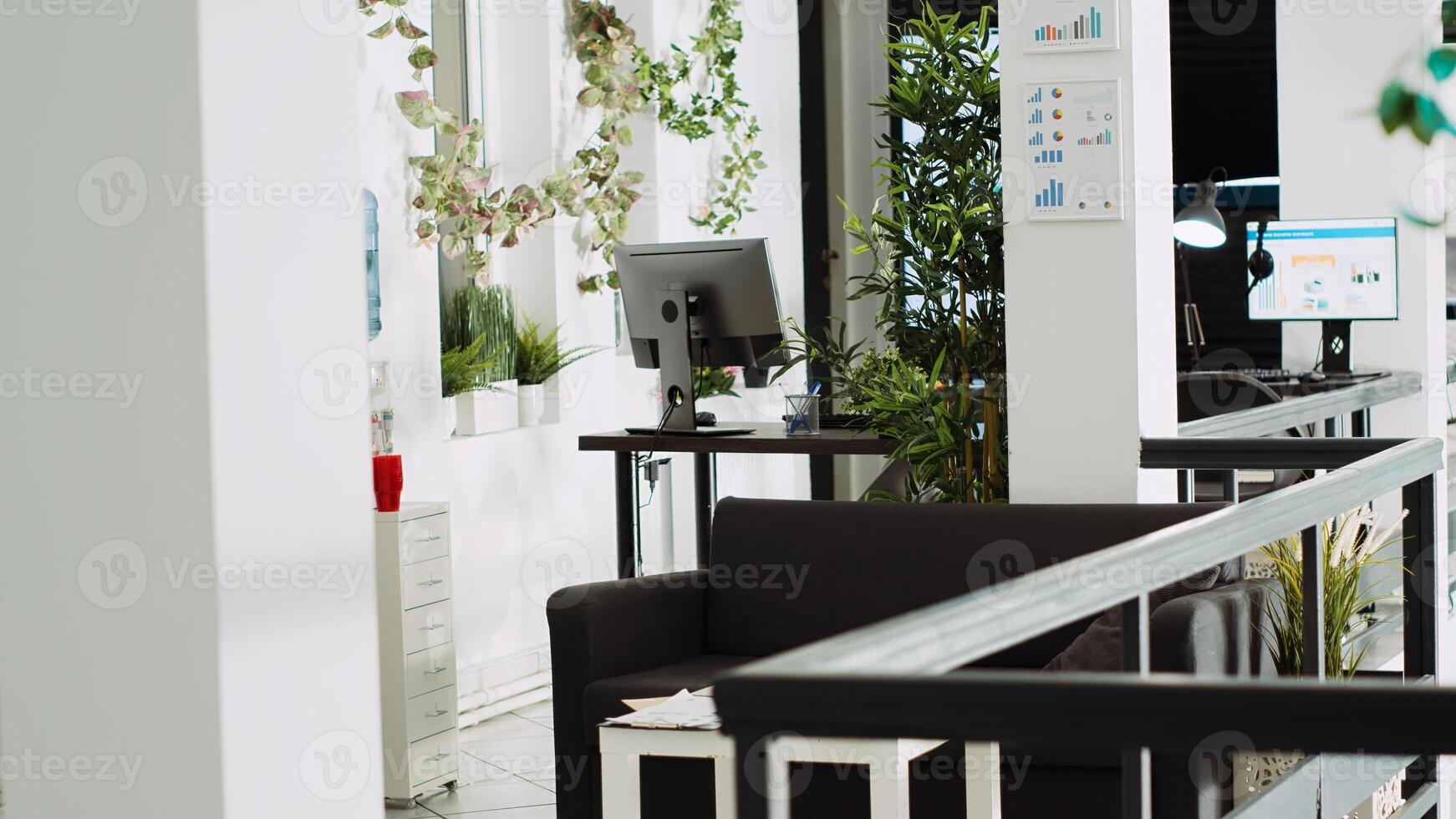 Empty small business office with startup workspaces and modern furniture, professional open space used for company work and meetings. Desks and computers in agency department. photo