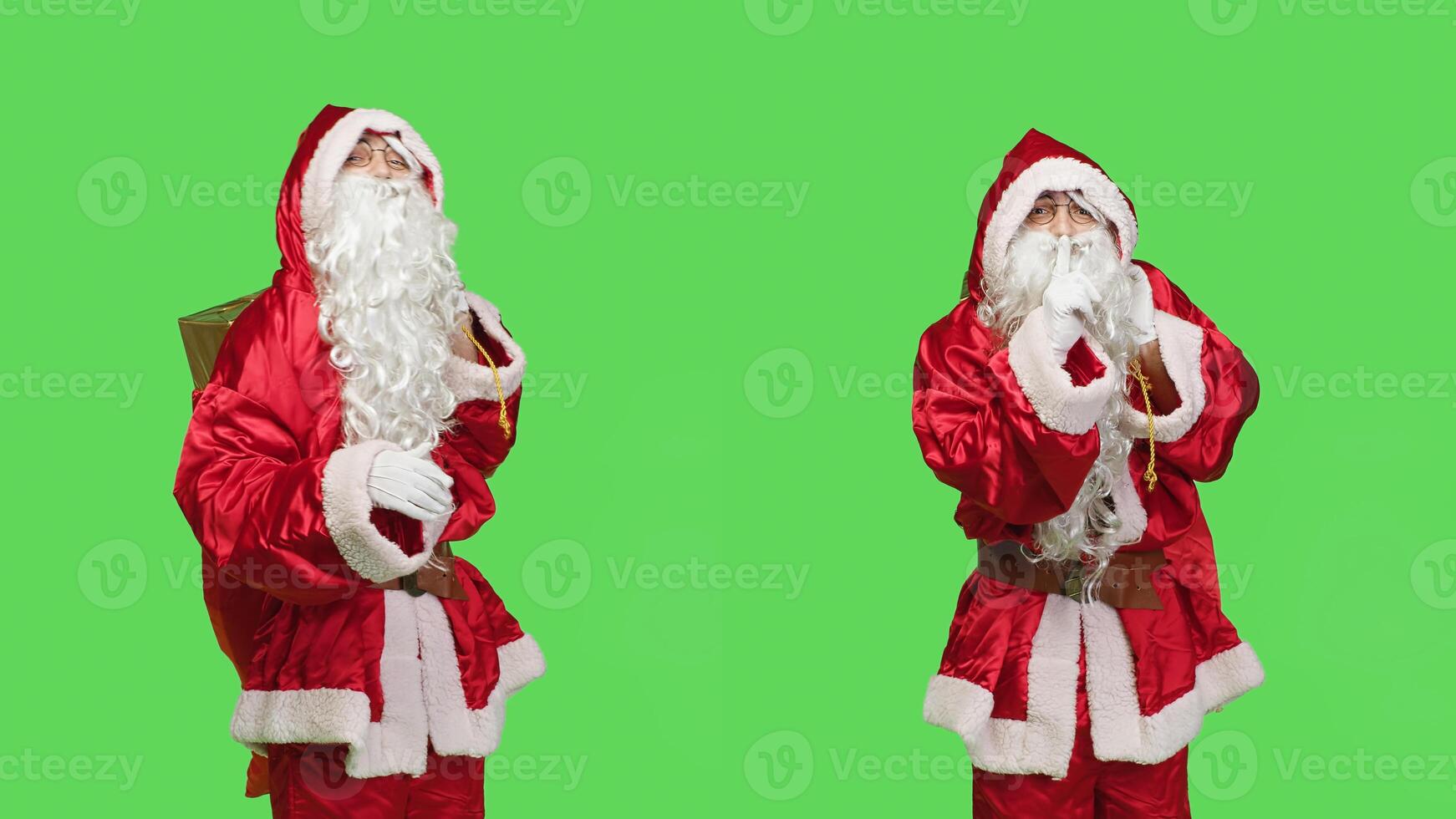 Father christmas shows mute symbol, espressing privacy and silence over greenscreen in studio. Santa claus with gifts bag doing hush sign to keep secret, private seasonal winter character. photo
