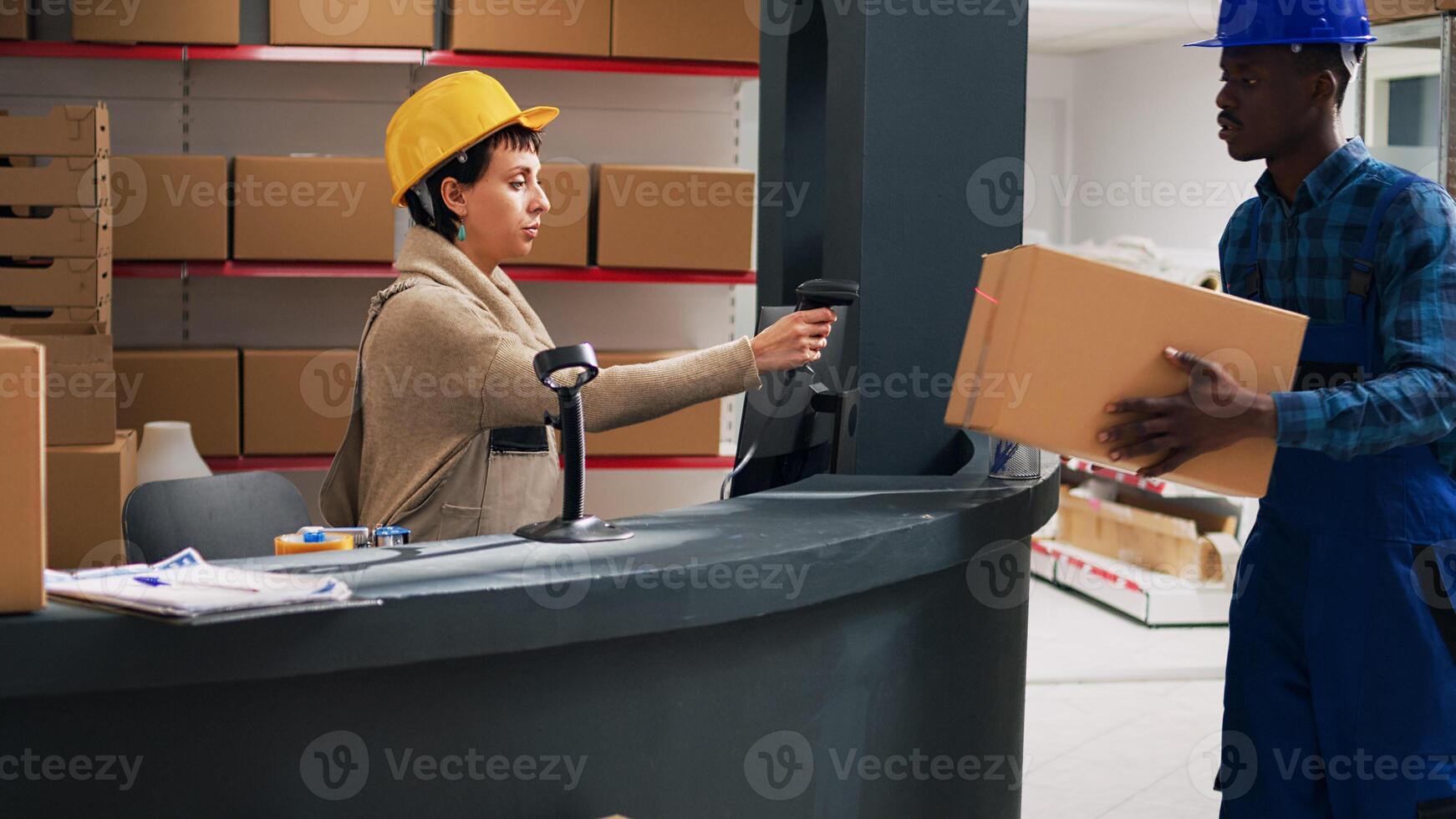 Female employee doing stock inventory with scanner, scanning barcodes on boxes with merchandise. Woman in overalls planning order shipment, industrial products in storage room. photo