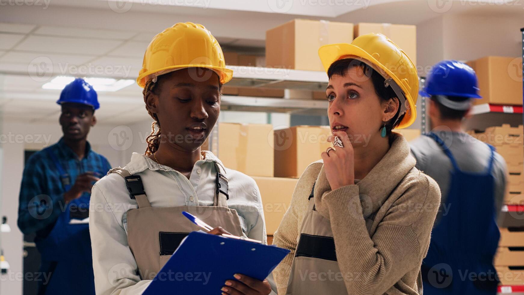 Diverse team of women counting number of merchandise in warehouse space, looking at products on racks and shelves. Young colleagues planning order distribution, checking cargo goods. photo