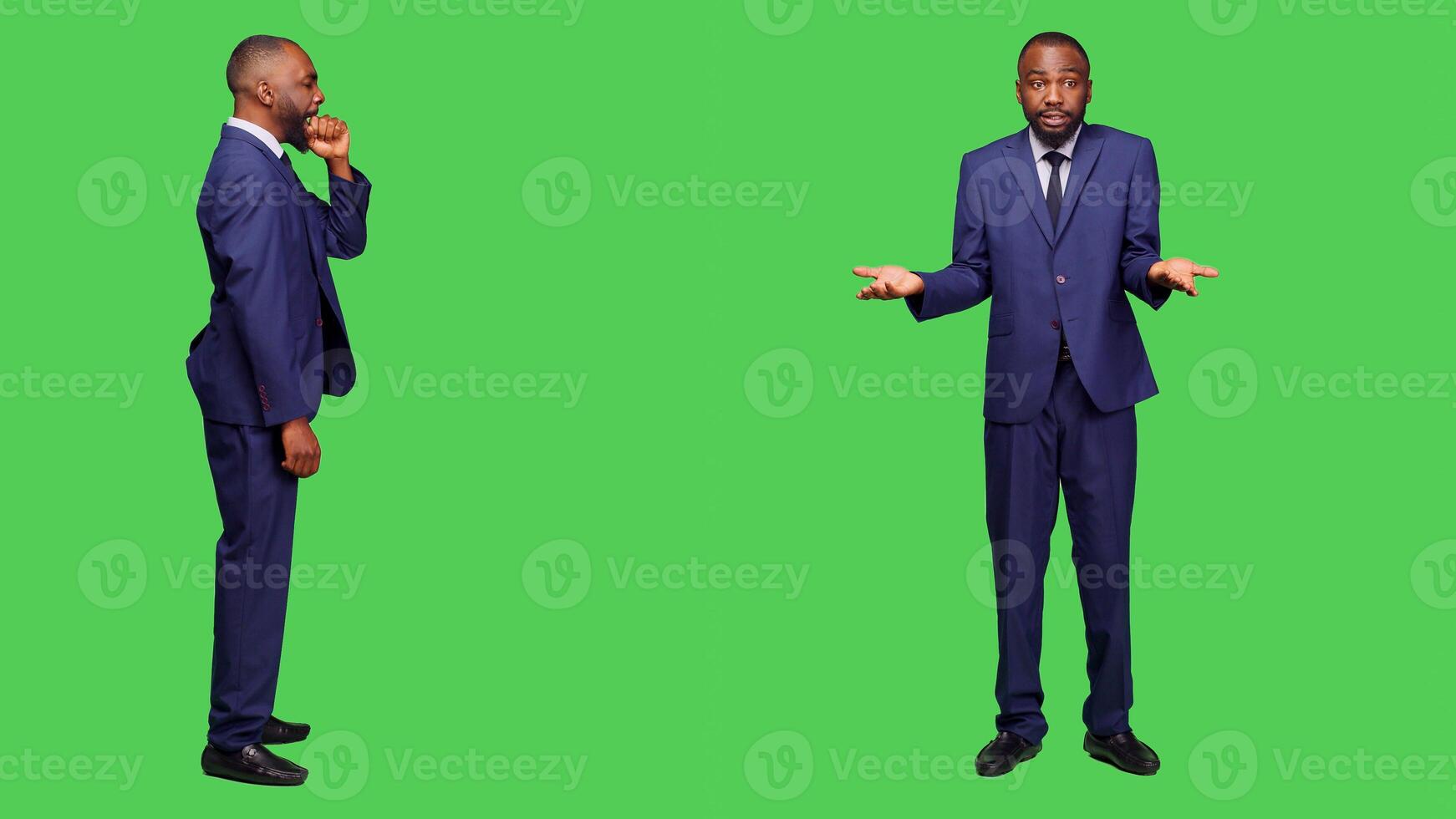 Young businessman feeling frustrated and exhausted in studio, yawning over full body greenscreen backdrop. Aggressive tired employee being displeased on camera, falling asleep. photo