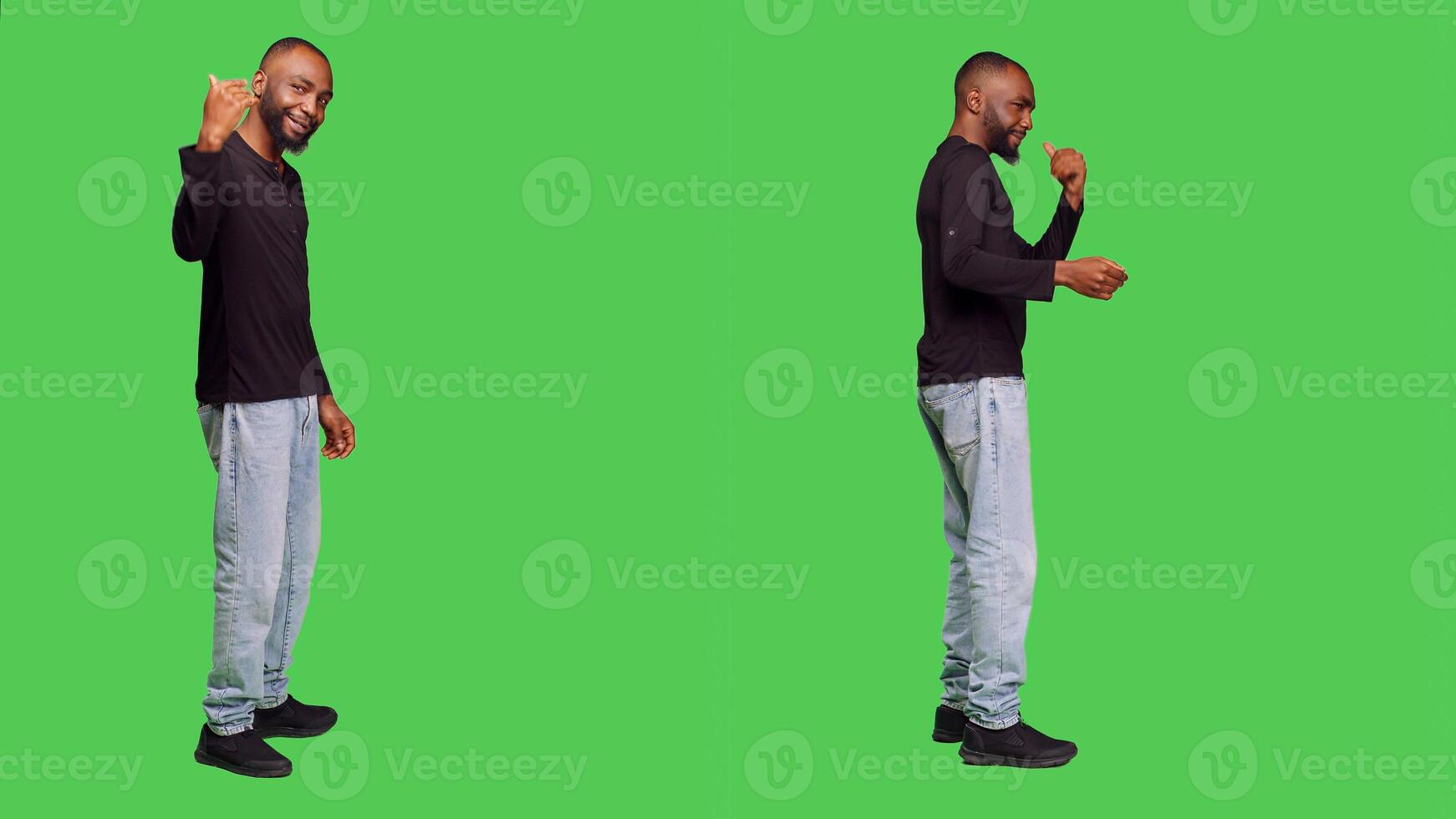 African american person asking someone to come over, posing with jeans and shirt over green screen backdrop. Male model standing in studio and calling someone over to accompany or join. photo